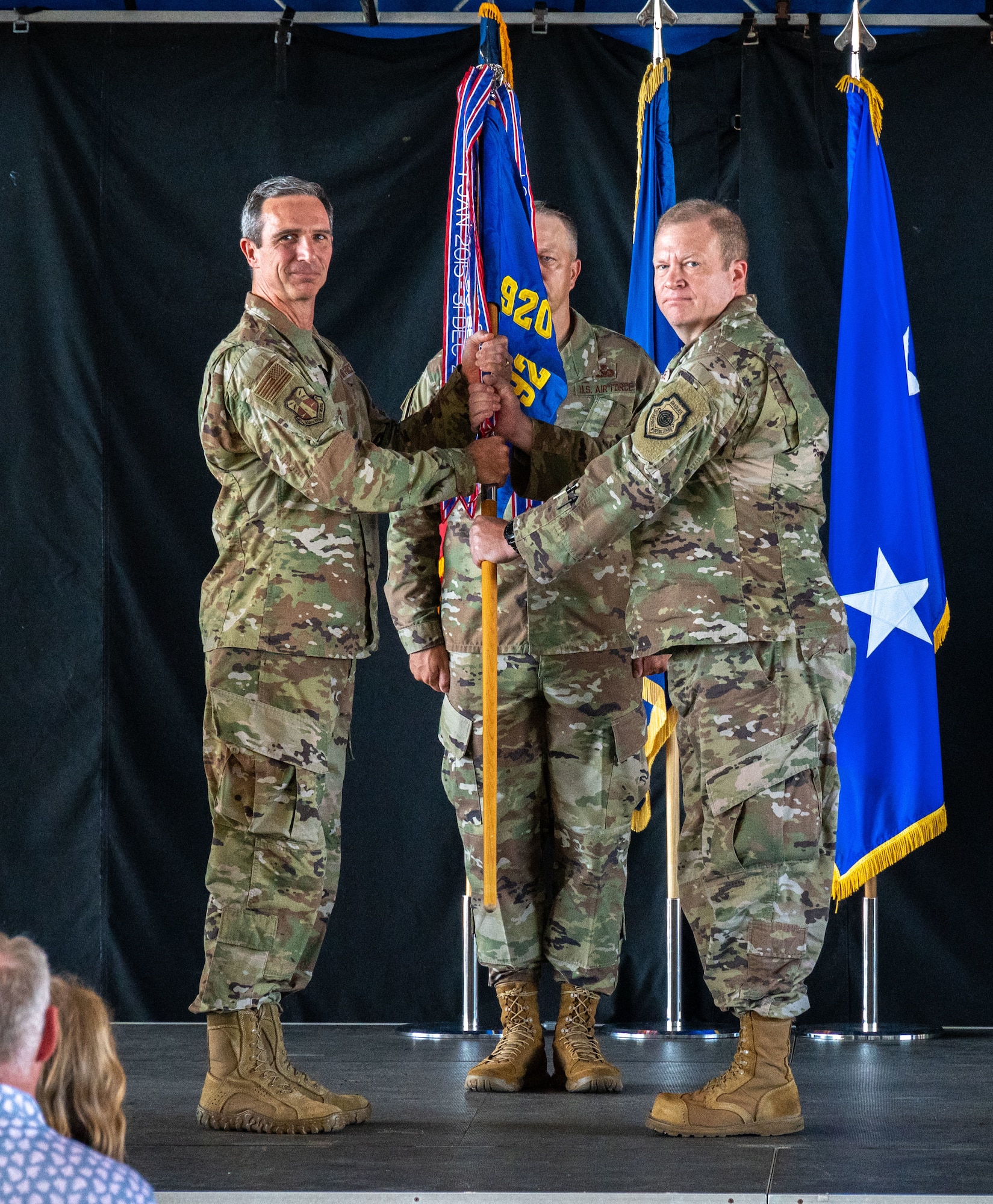 Lt. Gen. Bryan Radliff, 10th Air Force commander, presents the wing guidon to Col. Jesse Hamilton, incoming 920th Rescue Wing commander, during a change of command ceremony, Sept. 11, 2022, at Patrick Space Force Base, Florida. The change of command is a military tradition that formally signifies the transfer of responsibility and authority from one commanding officer to another; symbolized through the passing of a guidon. (U.S. Air Force photo by Master Sgt. Kelly Goonan)