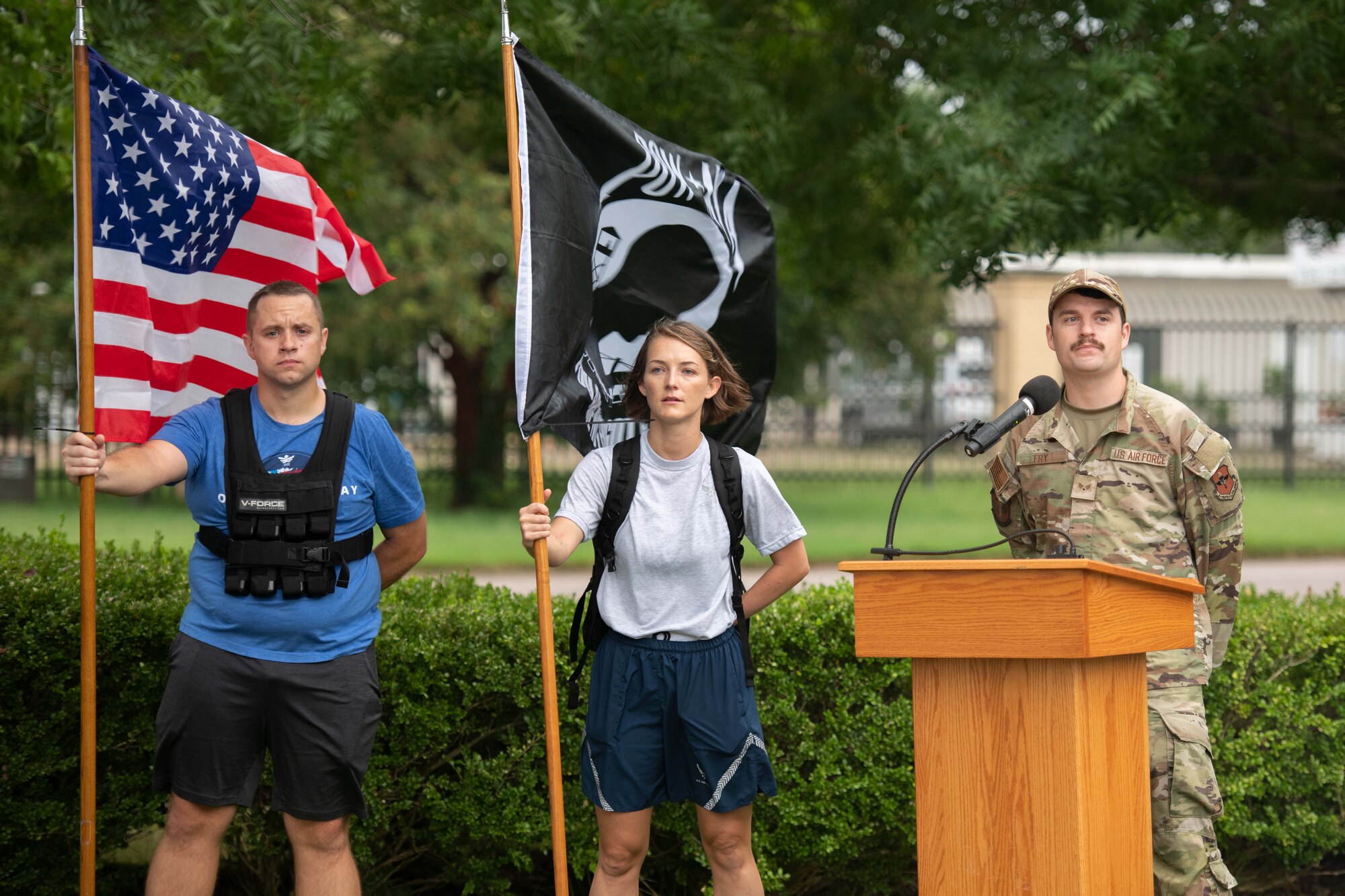 Airmen hold the flag during a stop while the speaker prepares for everyone to gather at Maxwell Air Force Base, September 9, 2022. The Ruck March happens every year to remember the fallen.