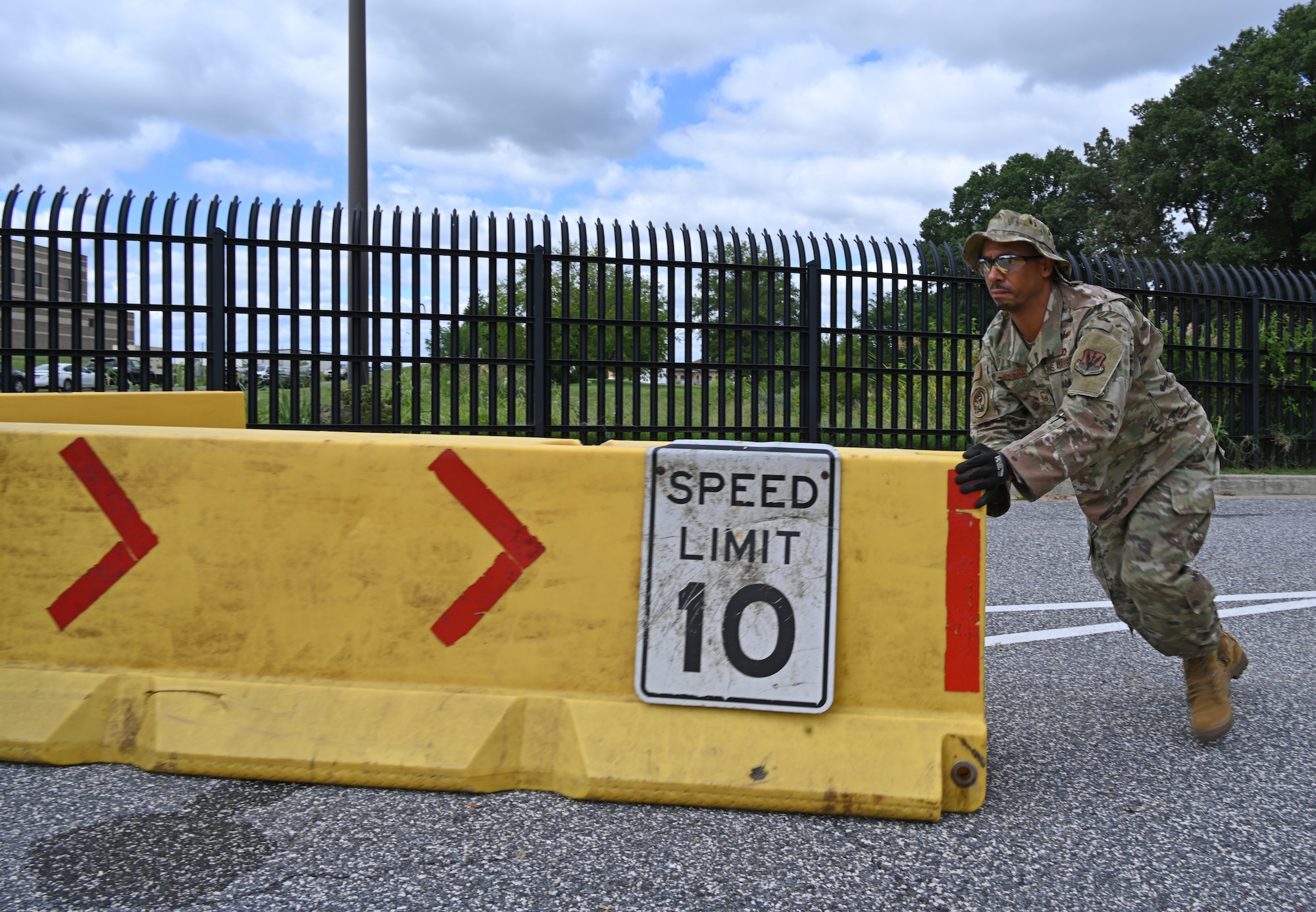 U.S. Air Force Master Sgt. Alvin Henson, facilities manager assigned to the 175th Civil Engineer Squadron, assists with setting up a barrier at the front gate of Warfield Air National Guard Base at Martin State Airport during an Anti-terrorism/force protection exercise at Warfield Air National Guard Base at Martin State Airport, Middle River, Md. on September 8, 2022.