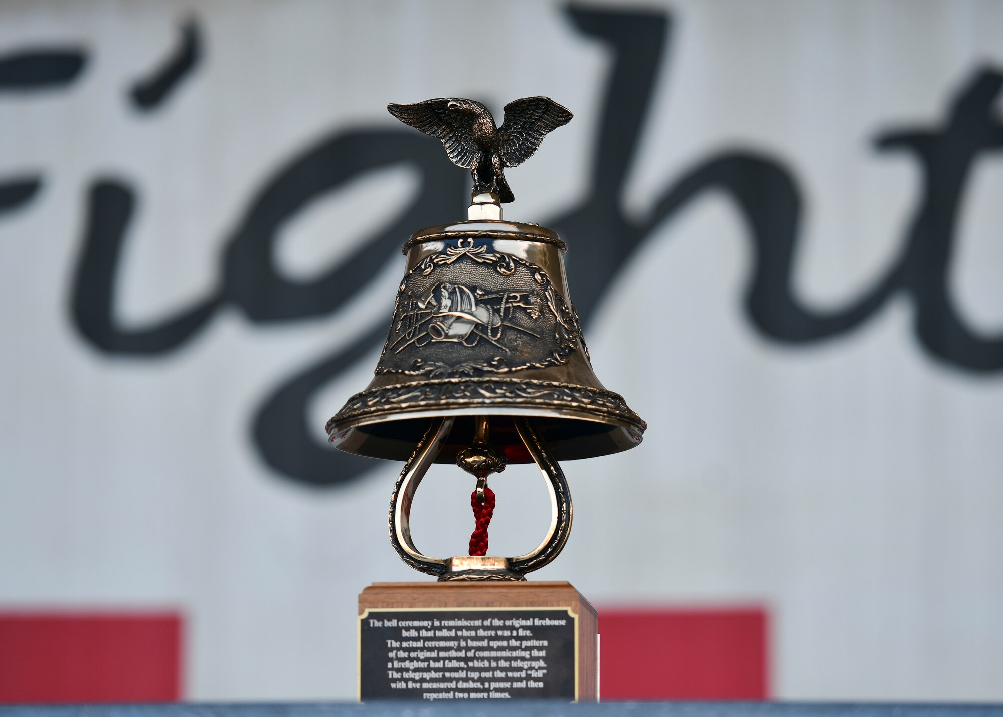 A first responder ceremonial bell is displayed onstage during a 9/11 remembrance ceremony at Kunsan Air Base, Republic of Korea, Sept. 8, 2022. The ceremonial bell is rung five times to announce a first responder's end of duties and return to quarters. (U.S. Air Force photo by Staff Sgt. Isaiah J. Soliz)
