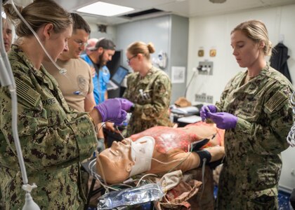 NORFOLK (Sept. 7, 2022) Expeditionary Resuscitative Surgical System (ERSS) surgeons and hospital corpsman assigned to Naval Medical Center Portsmouth perform emergency surgery and advanced trauma care on mannequins during a realistic test-of-concept aboard the Whidbey Island-class dock landing ship, USS Tortuga (LSD-46), Sept. 7, 2022. ERSS is designed to provide advanced medical capabilities at the closest point-of-injury, either afloat, undersea or ashore during combat or contingency operations in a distributed maritime environment. (U.S. Navy photo by Mass Communication Specialist 1st Class Ryan Seelbach)