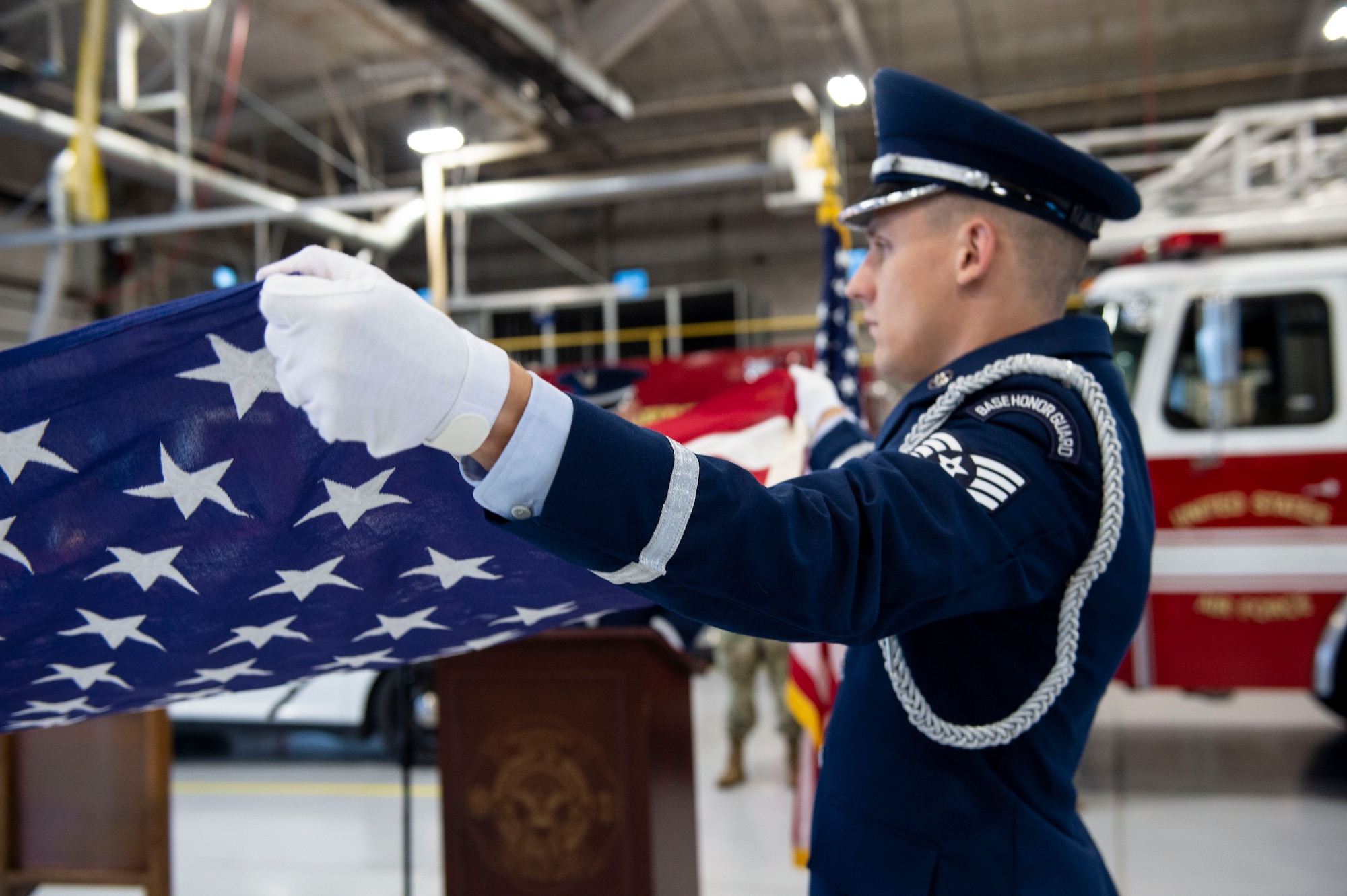 Staff Sgt. Ryan Webster, Grissom honor guardsmen, holds the flag out during a flag folding ceremony during the 9/11 Remembrance ceremony, September 11, 2022, at Grissom Air Reserve Base, Indiana. The ceremony marked the 21st anniversary of the events of September 11, 2001. (U.S. Air Force photo by Staff Sgt. Alexa Culbert)