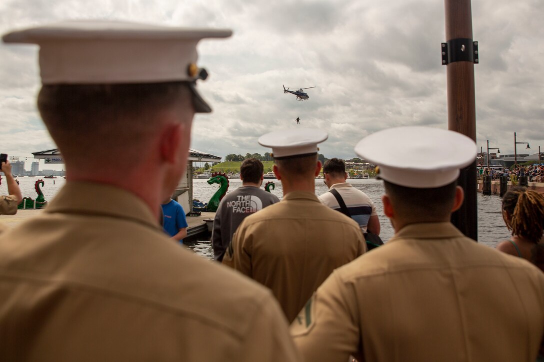 U.S. Marines with Chemical Biological Incident Response Force observe a helicopter rescue demonstration from the Baltimore County Police Department during Maryland Fleet Week & Flyover Baltimore, Sept. 9, 2022. Maryland Fleet Week & Flyover Baltimore is an annual public event that provides the opportunity for the U.S. Marine Corps, U.S. Navy and U.S. Coast Guard to engage with each other and civilians. More than 2,300 service members participated in Maryland Fleet Week 2022 engaging and assisting with ship tours, live bands and community service events. (U.S. Marine Corps photo by Sgt. Kealii De Los Santos)