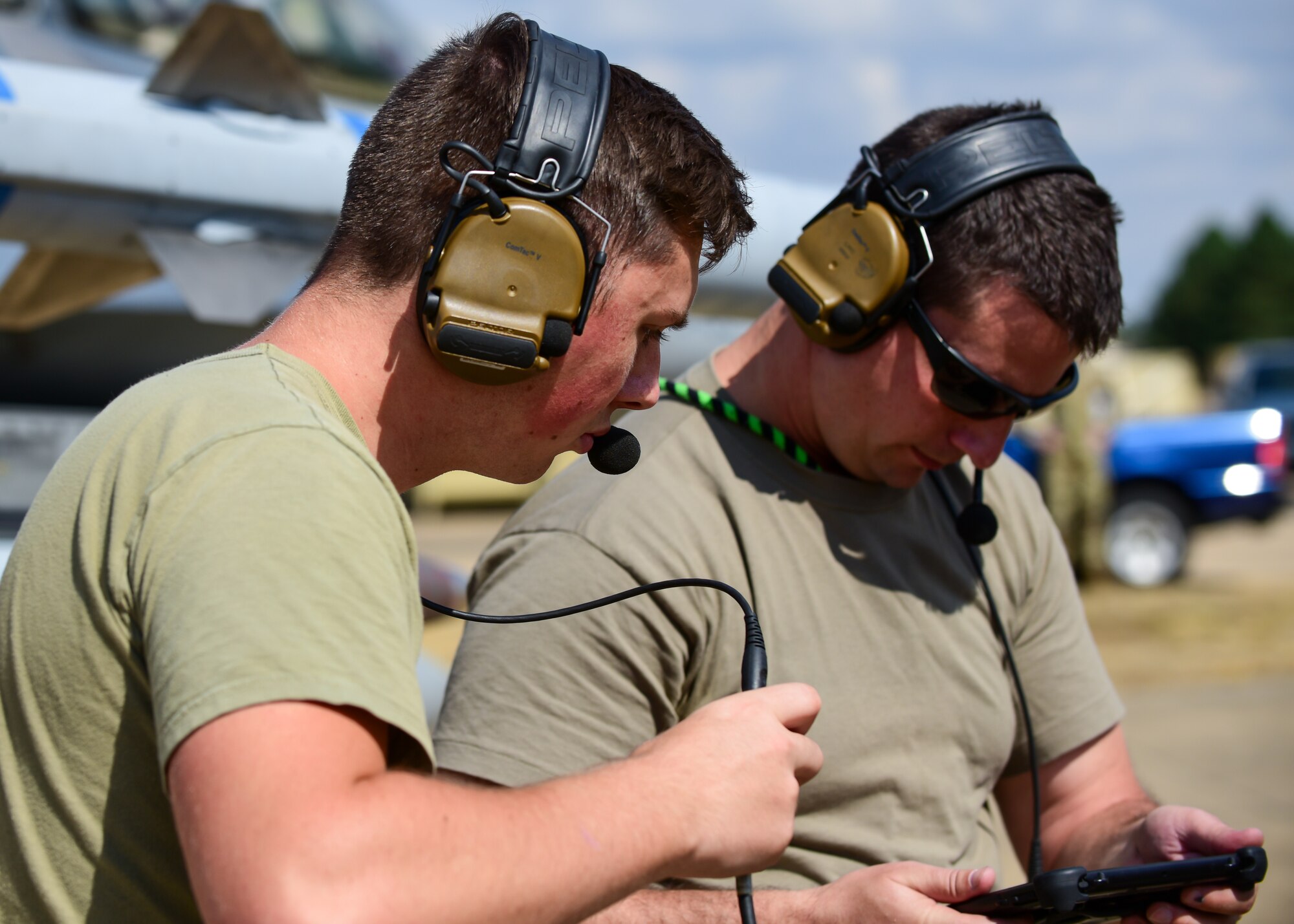 Senior Airman Juston Hyden (left) and Tech. Sgt. Craig Pitz (right), 555th Fighter Generation Squadron aerospace propulsion technicians from the 31st Fighter Wing, Aviano Air Base, Italy, reference a technical order manual of an F-16C Fighting Falcon during pre-flight checks