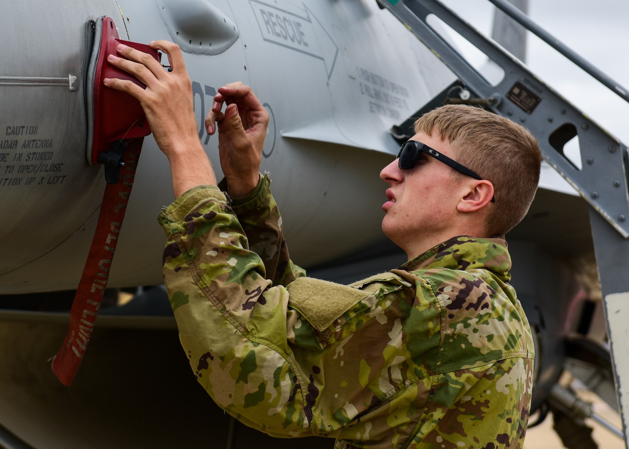 Airman 1st Class Jacob Webber, 555th Fighter Generation Squadron crew chief from the 31st Fighter Wing, Aviano Air Base, Italy, places an angle-of-attack cover on an F-16C Fighting Falcon