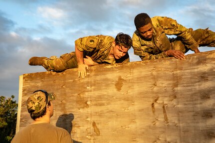 Virginia Army National Guard Soldiers assigned to Task Force Red Dragon, Combined Joint Task Force-Horn of Africa, navigate an obstacle course during a spur ride Aug. 20, 2022, in Manda Bay, Kenya. The spur ride included physical training events, an obstacle course, rifle and pistol live-fire, weapons familiarization, reconnaissance and medical evacuation lanes, and a night call for fire and crew-served weapons live-fire event.