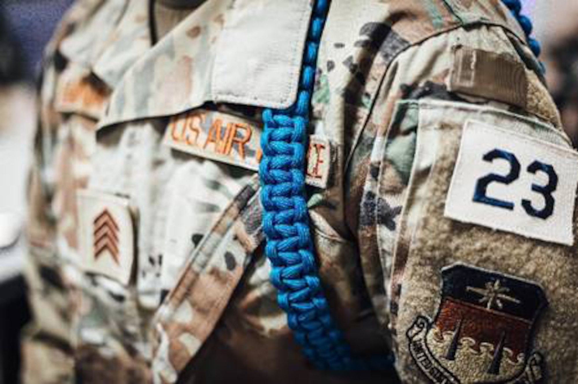 USAFA Cadet wears teal rope indicating sexual assault awareness and support.