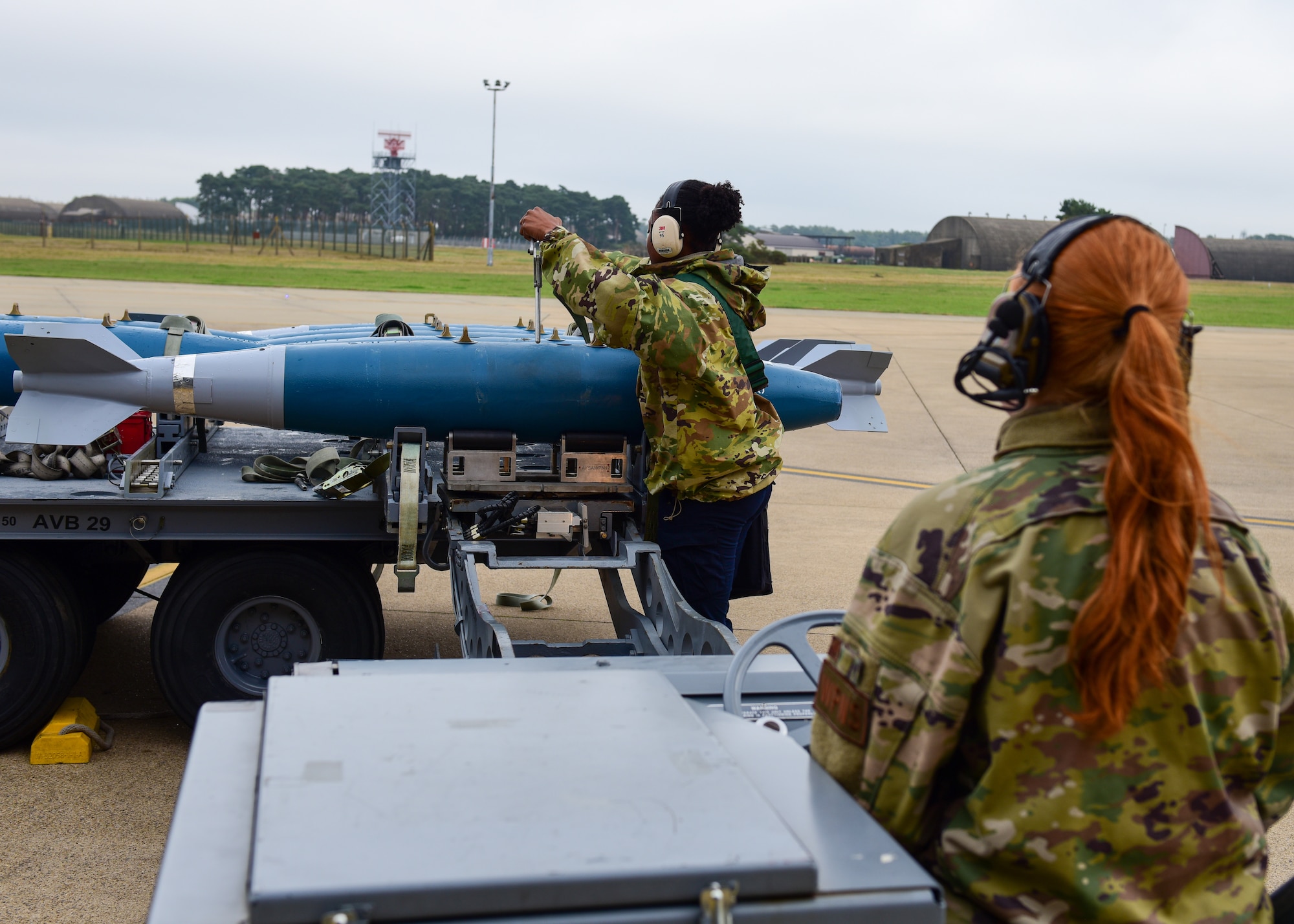 Senior Airman Molly Thomas 555th Fighter Generation Squadron weapons load crew member and U.S. Air Force Staff Sgt. Samill Harkness, 555th Fighter Generation Squadron weapons load crew chief, from the 31st Fighter Wing, Aviano Air Base, Italy, unload missiles before securing it onto aircraft