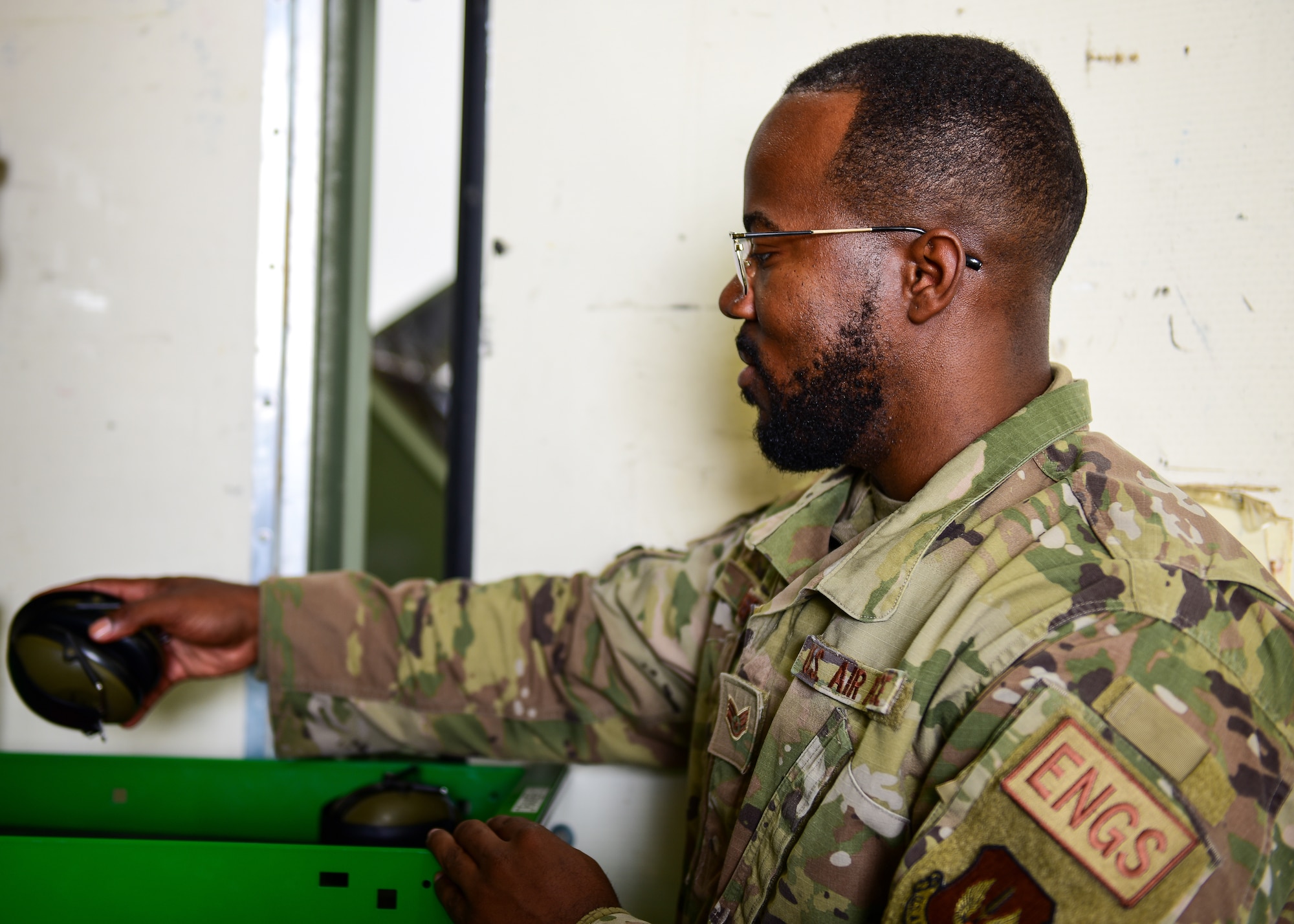 U.S. Air Force Staff Sgt. Famous Roberts, 555th Fighter Generation Squadron support technician from the 31st Fighter Wing, Aviano Air Base, Italy, sets hearing protection in place
