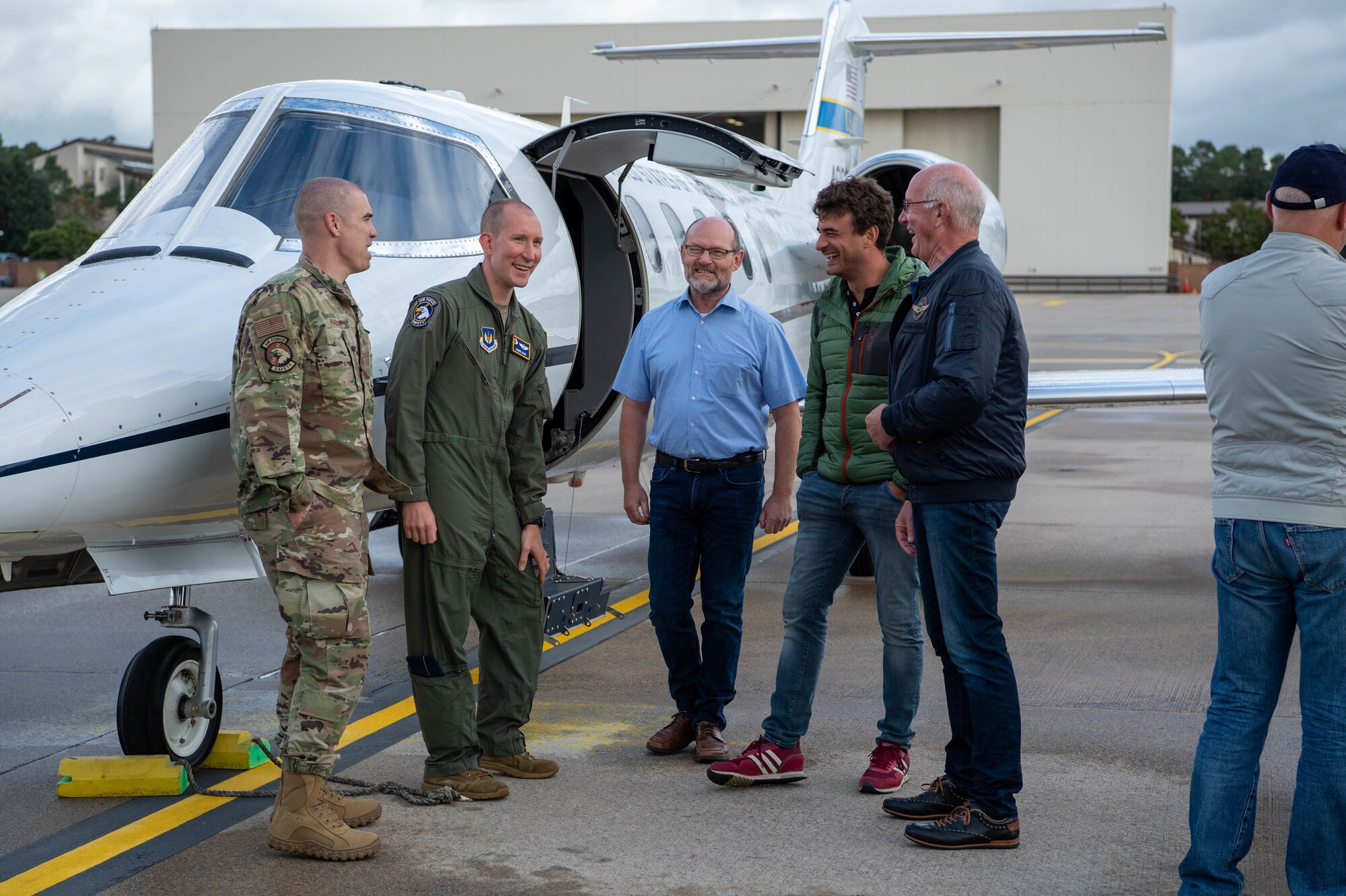 A group of glider pilots from various flying clubs in Rheinland-Pfalz gather to tour a C-21 Learjet 35 aircraft at Ramstein Air Base, Sept. 9, 2022 during a Mid-Air Collision Avoidance Meeting.