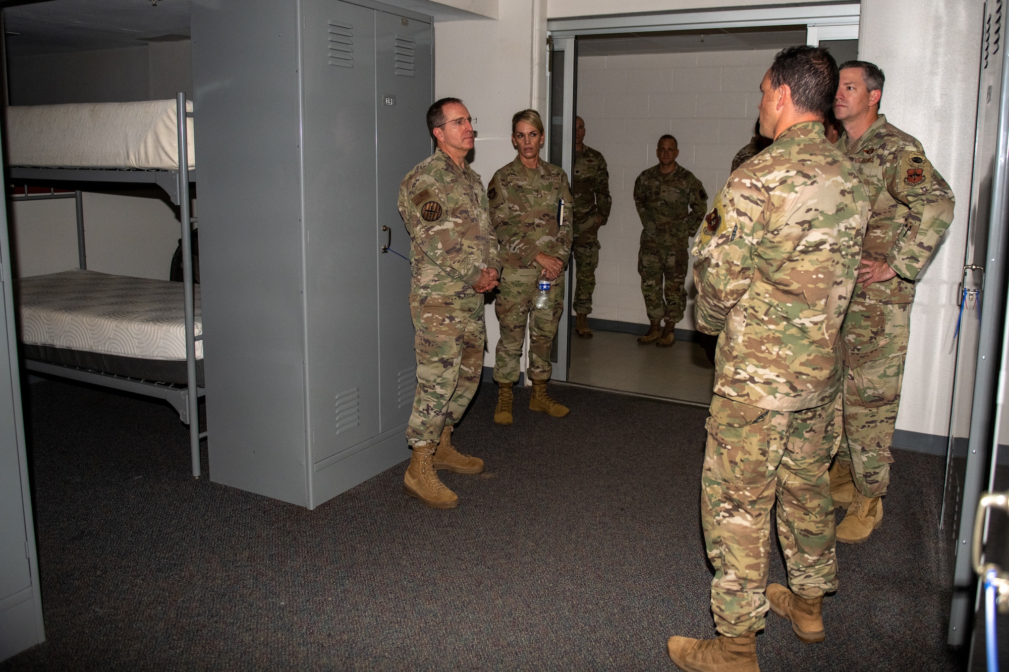 U.S. Air Force Lt. Gen. James “Jim” Slife (near center), Air Force Special Operations Command commander, and Maj. Gen. Michele Edmondson (far center), 2nd Air Force commander, observe open-bay mixed-sex facilities at the Special Warfare Candidate Course where male and female trainees bunk together at Joint Base San Antonio-Lackland, Texas, Aug. 19, 2022. Modified mixed-sex facilities were built at the Special Warfare Training Wing to ensure appropriate levels of privacy for mixed-sex cohorts of trainees and to bolster diversity, inclusion and integration.