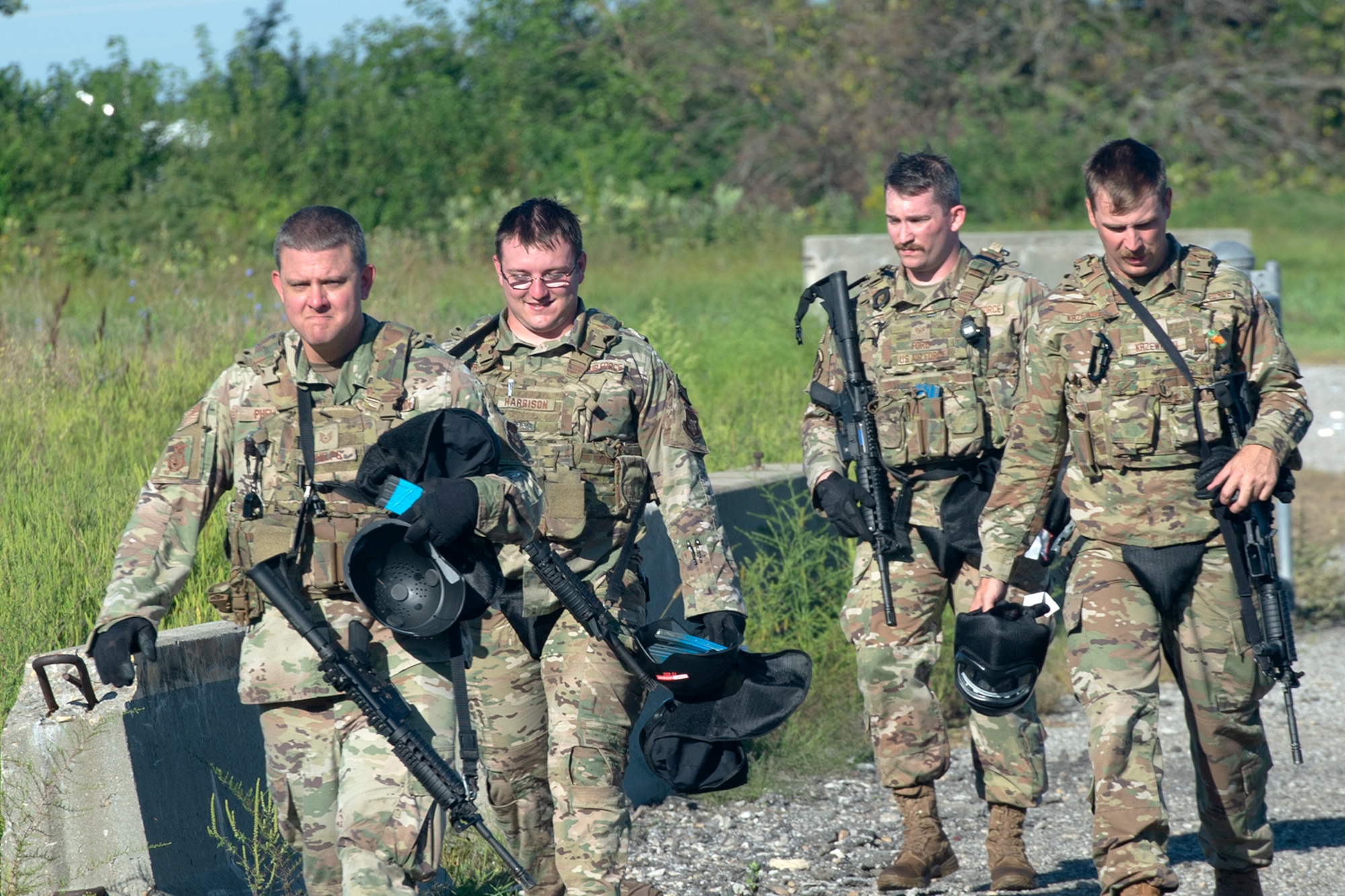 Airmen from the 434th Security Forces at Grissom Air Reserve Base, Ind. head back to the staging area after running through a scenario during “shoot, move, communicate” training on Sept. 1, 2022. SMC training tests defenders’ ability to work as a team and communicate during a fire fight. (U.S. Air Force photo by Master Sgt. Rachel Barton)