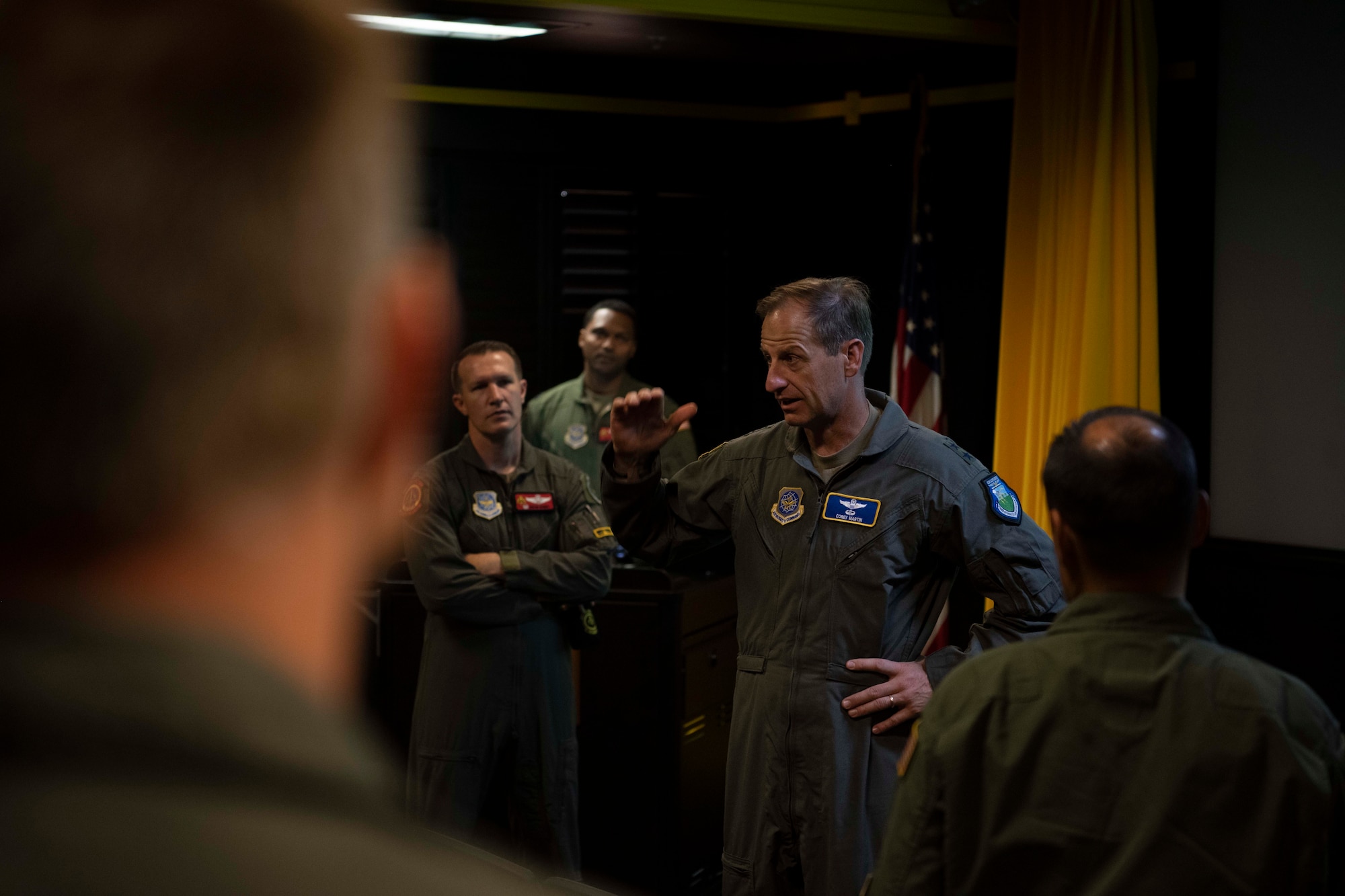 An Airman speaks to a group of Airmen.