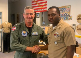 SPARKS, Nev. (Sept. 9, 2022) Rear Adm. Pete Garvin, commander, Naval Education and Training Command (NETC), left, poses for a photo with Machinist Mate 2nd Class James Hypolite, a recruiter at Navy Recruiting Station Sparks, Nevada, during a visit Sept. 9, 2022.