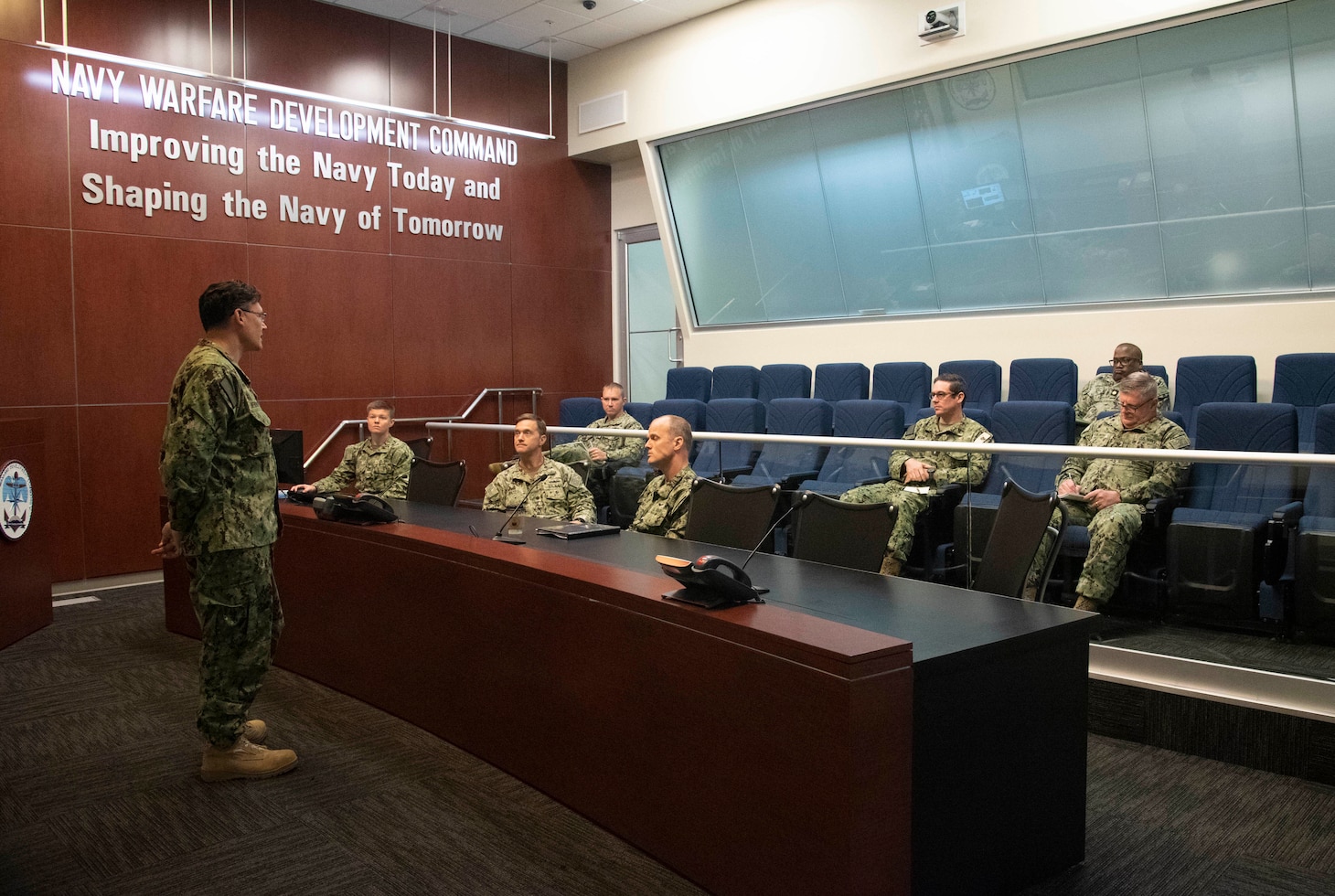 Maritime Operations Center Director Capt. Patrick Newbrough, commanding officer, U.S. Naval Forces Central Command consults with the operational planning team to discuss challenges and responses to events occurring during maritime operations center exercise in Norfolk. The maritime operations center exercise, comprised of 10 units, is a training exercise by Reserve Sailors, for Reserve Sailors to strategically align with mission requirements to support the fleet in the four lines of effort which are design, train, mobilize and develop. (U.S. Navy photo by Mass Communications Specialist 1st Class Helen Brown)