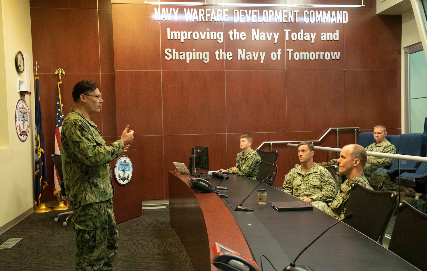 Maritime Operations Center Director Capt. Patrick Newbrough, commanding officer, U.S. Naval Forces Central Command consults with the operational planning team to discuss challenges and responses to events occurring during a maritime operations center exercise in Norfolk. The maritime operations center exercise, comprised of 10 units, is a training exercise by Reserve Sailors, for Reserve Sailors to strategically align with mission requirements to support the fleet in the four lines of effort which are design, train, mobilize and develop. (U.S. Navy photo by Mass Communications Specialist 1st Class Helen Brown)