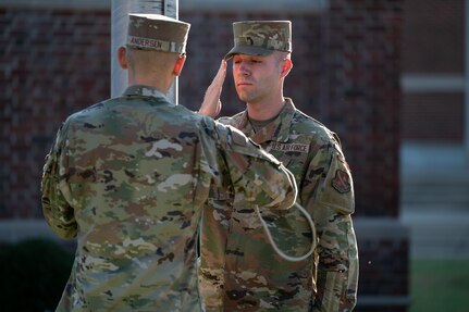 Airman 1st Class Justin Andersen and Airman 1st Class Christian Anderson of The United States Air Force Honor Guard raise the American flag during the 9/11 Remembrance Ceremony at Joint Base Anacostia-Bolling, Washington, D.C., Sept. 9, 2022. The annual event is held in honor of those who lost their lives during the terrorist attacks at the World Trade Center and Pentagon on Sept. 11, 2001, and in remembrance of those who responded. (U.S. Air Force photo by Kristen Wong)