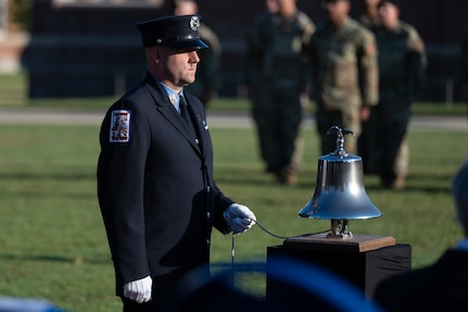 Bradley Reppert of the Fire Department of the City of New York tolls a bell in honor of the 2,996 lives lost on Sept. 11, 2001, during the 9/11 Remembrance Ceremony at Joint Base Anacostia-Bolling, Washington, D.C., Sept. 9, 2022. The annual event is held in honor of those who lost their lives during the terrorist attacks at the World Trade Center and Pentagon on Sept. 11, 2001, and in remembrance of those who responded. (U.S. Air Force photo by Kristen Wong)