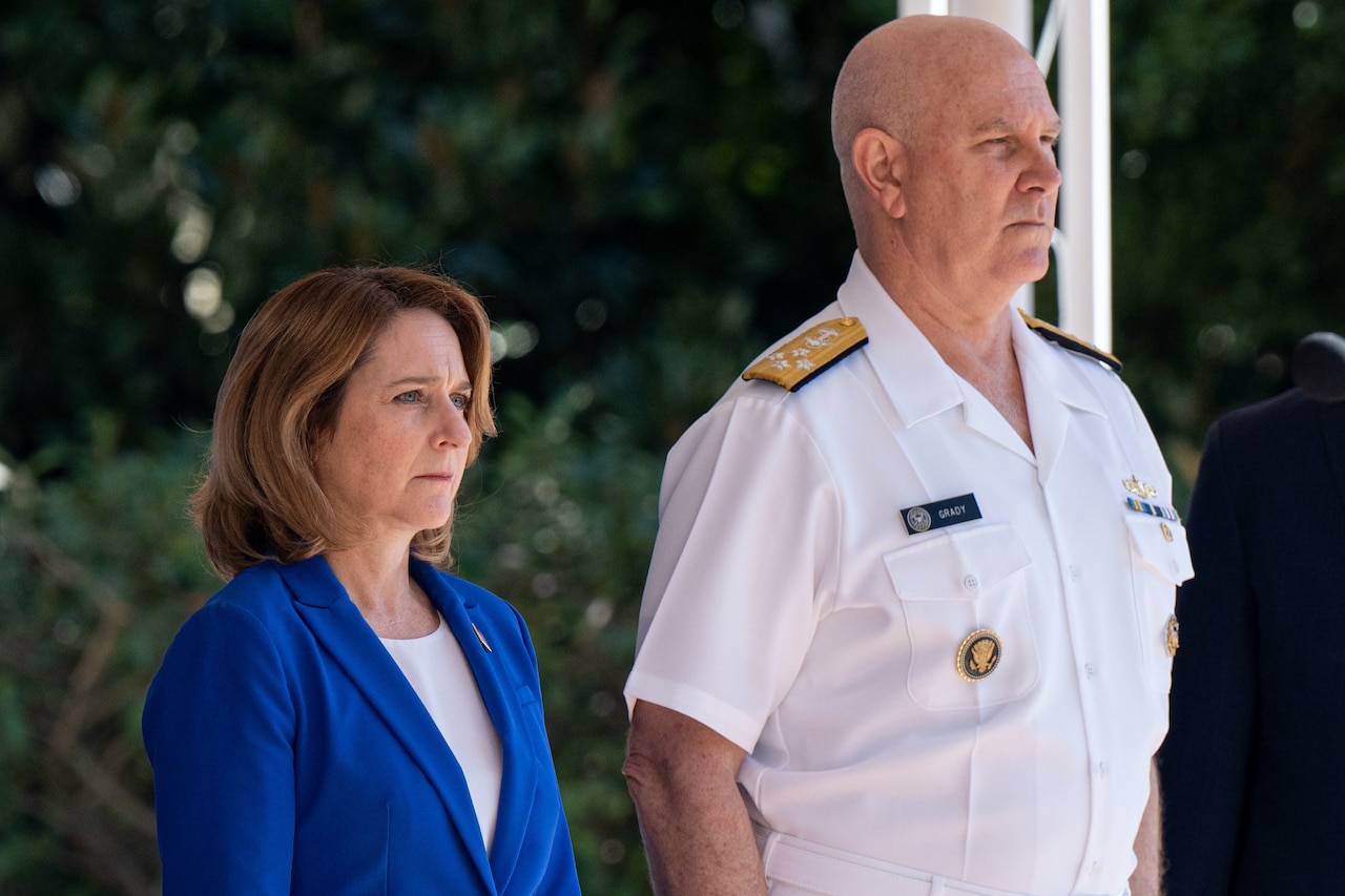A man and woman stand next to each other.