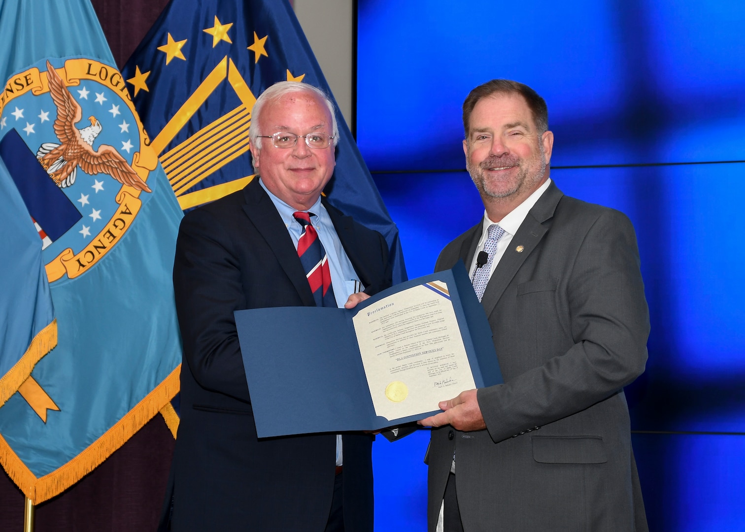 Two men hold a proclamation.