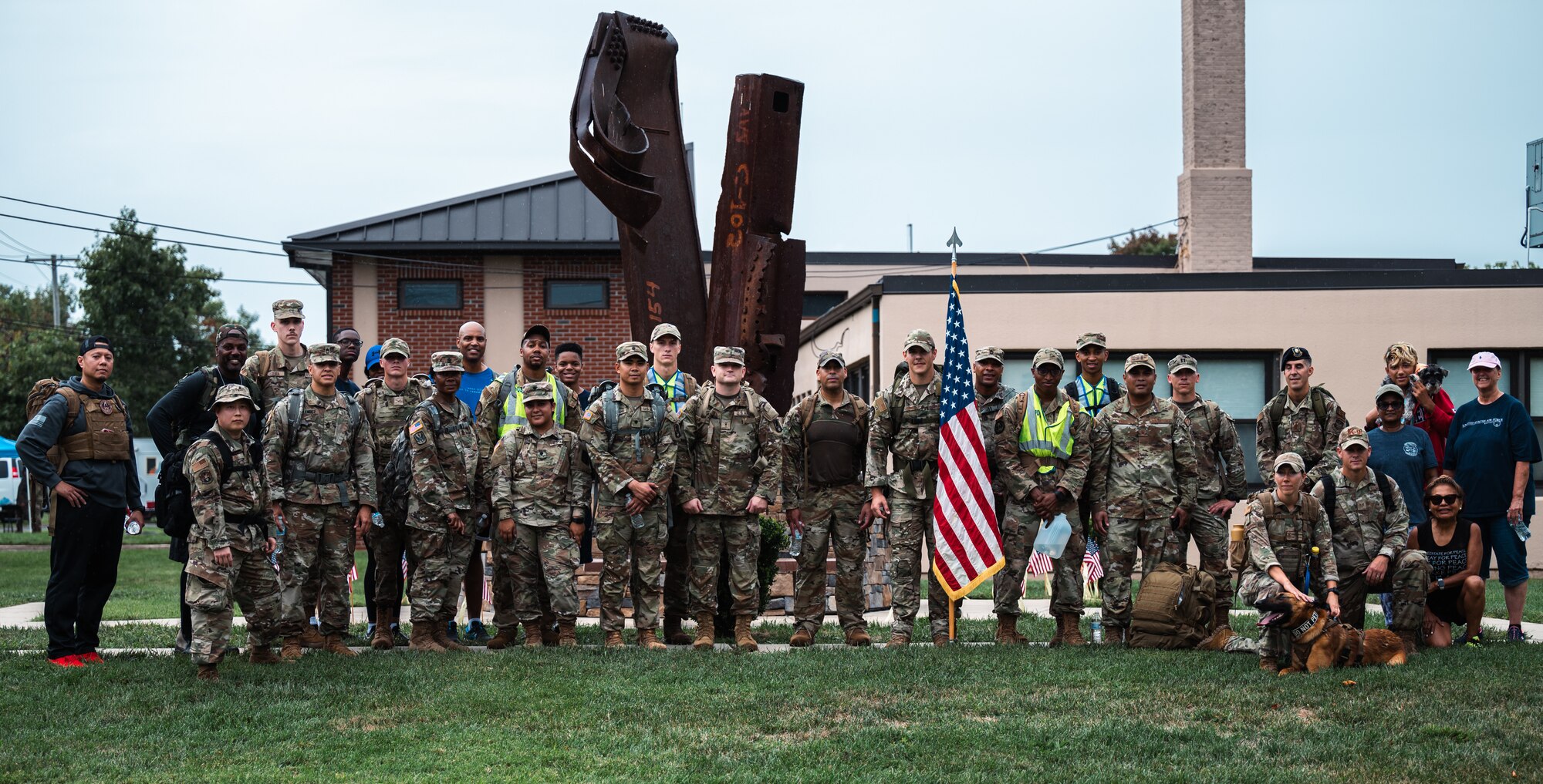 Service members assigned to Joint Base McGuire-Dix-Lakehurst pose for a photo after a 9/11 memorial ruck march at Joint Base MDL, N.J., Sept. 11, 2022.