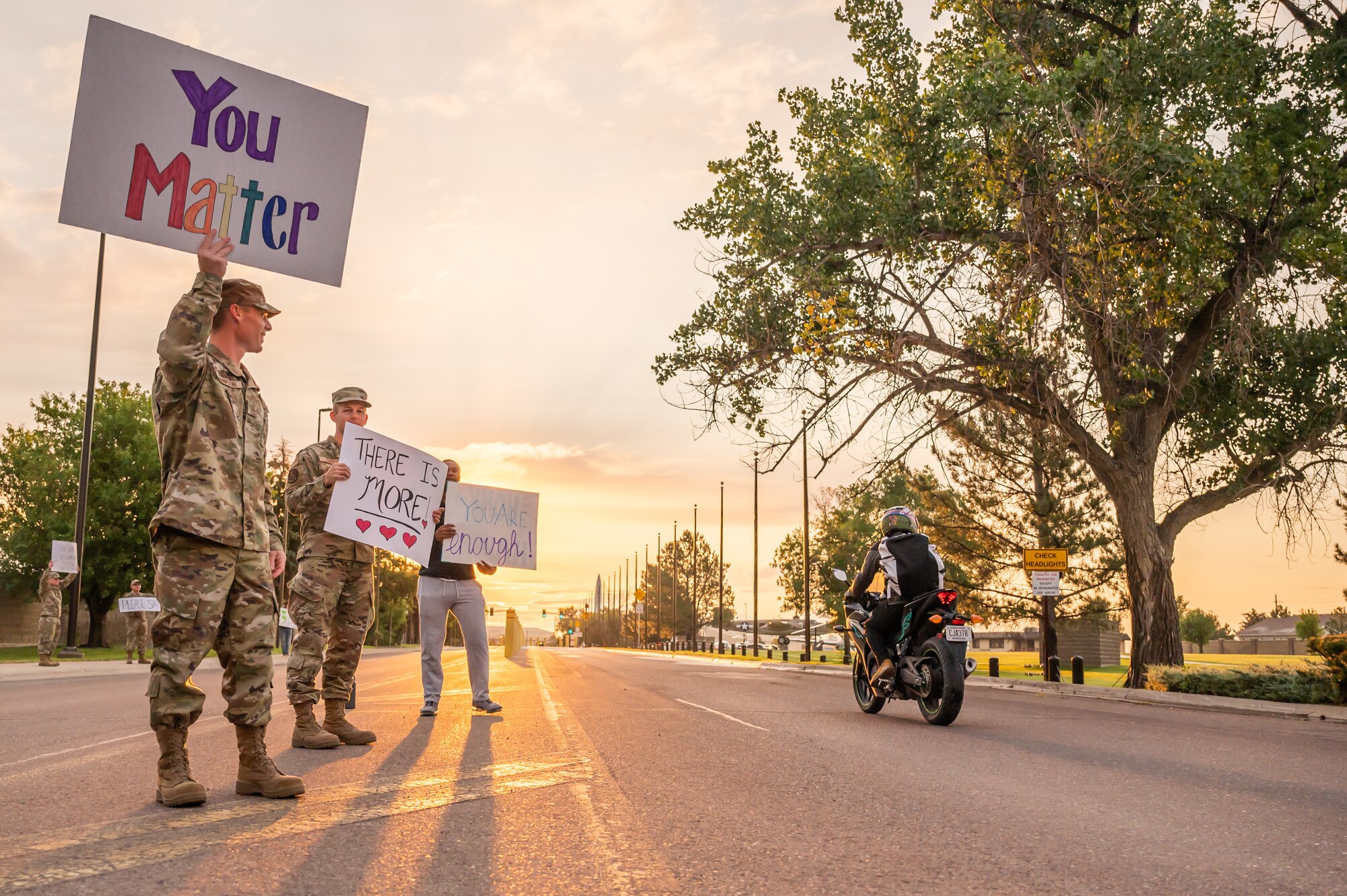 Members of the 341st Missile Wing greet people entering the installation during a Signs of Hope event Sept. 9, 2022, at Malmstrom Air Force Base, Mont.