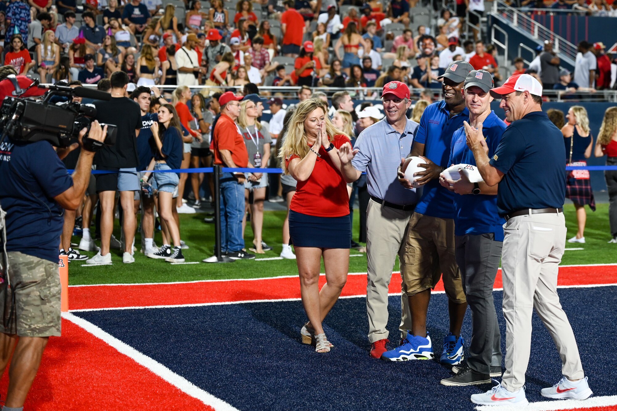 A photo of military members receiving autographed football.