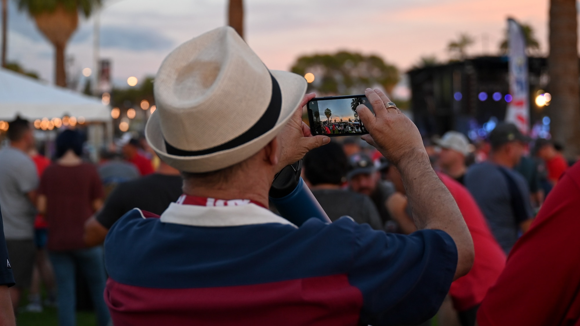 A photo of a man taking a photo of the sky.
