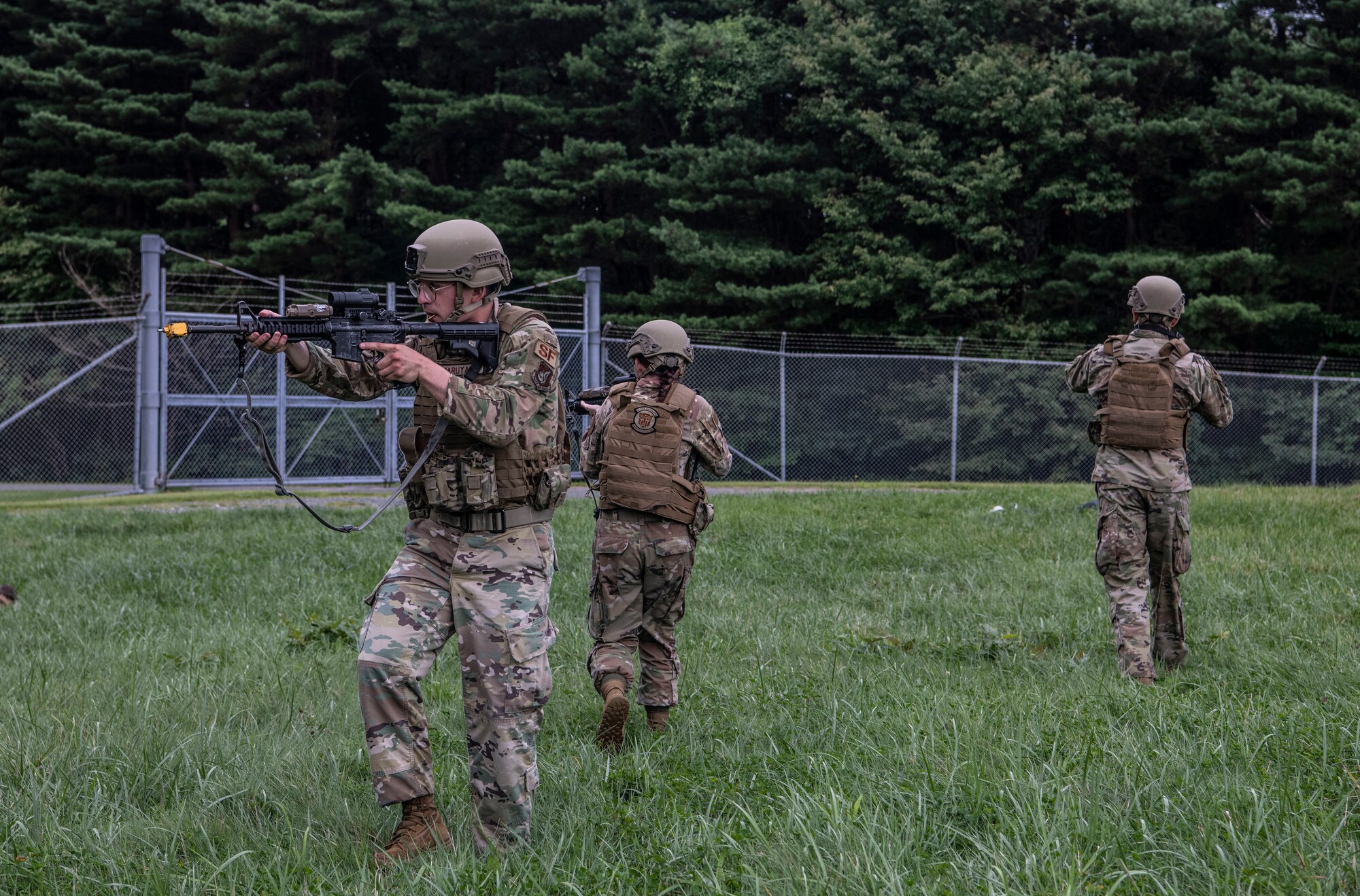 U.S. Air Force members holding rifles respond to a simulated perimeter breach.