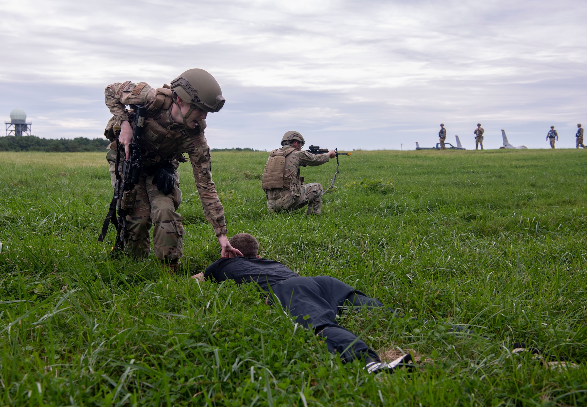 U.S. Air Force members holding rifles respond to a simulated perimeter breach.