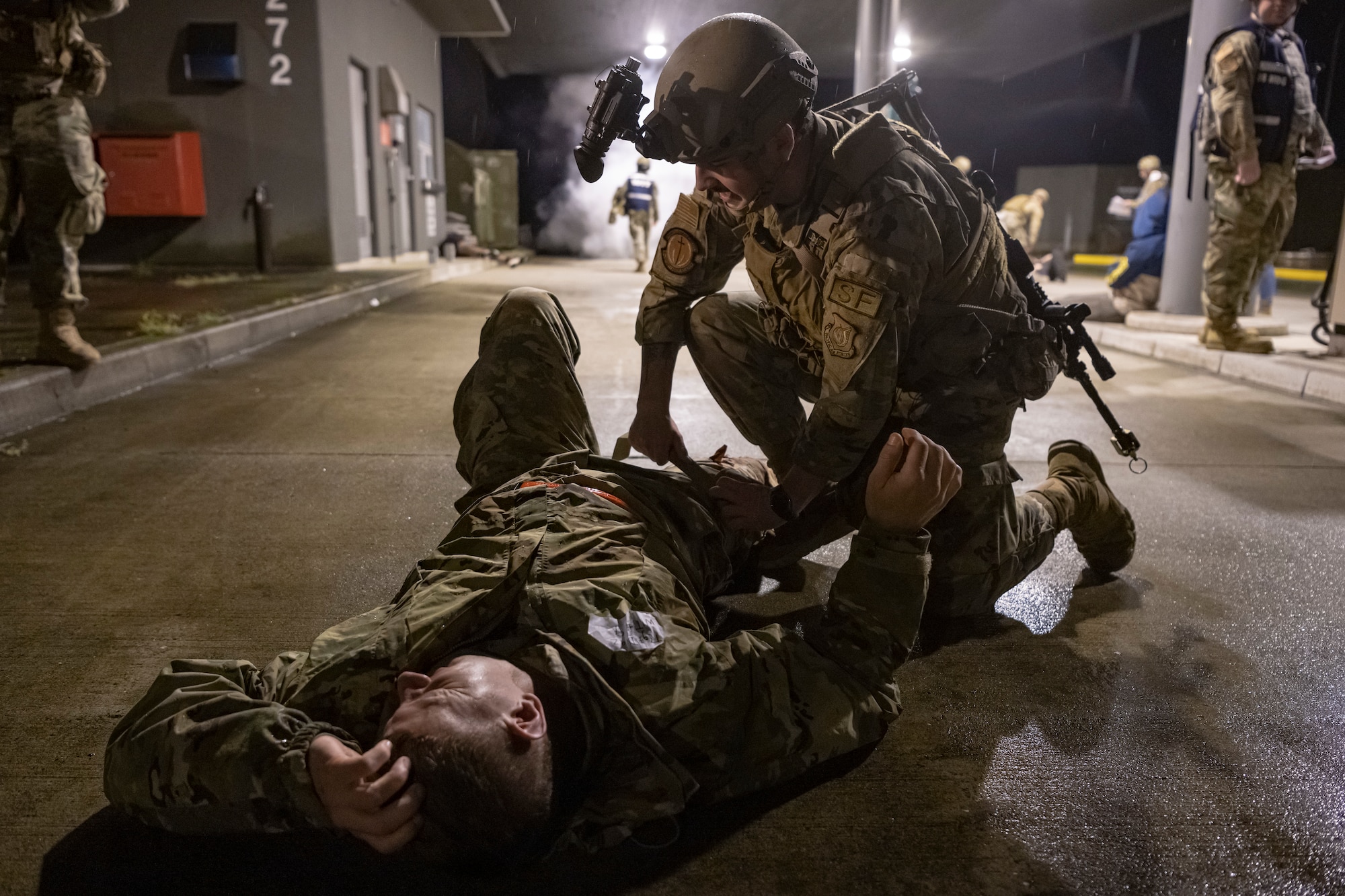 A U.S. Air Force member conducts medical care on a simulated victim.