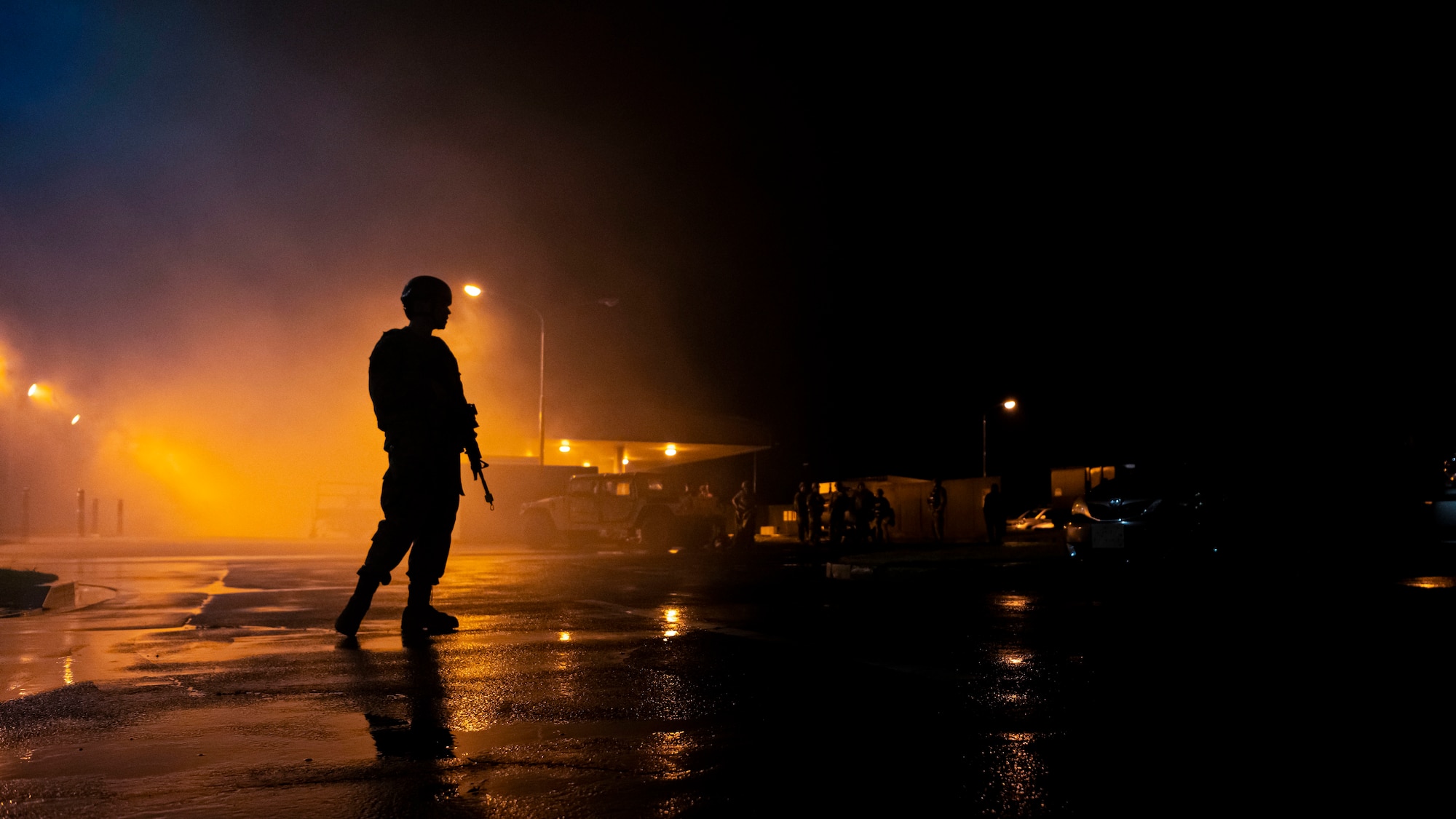 U.S. Air Force member conducts patrol on the perimeter of an incident scene.