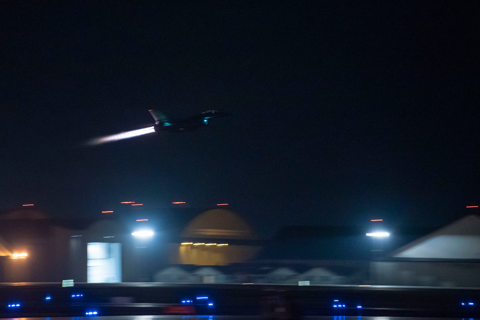 F-16 Fighting Falcon takes off of the runway at night.