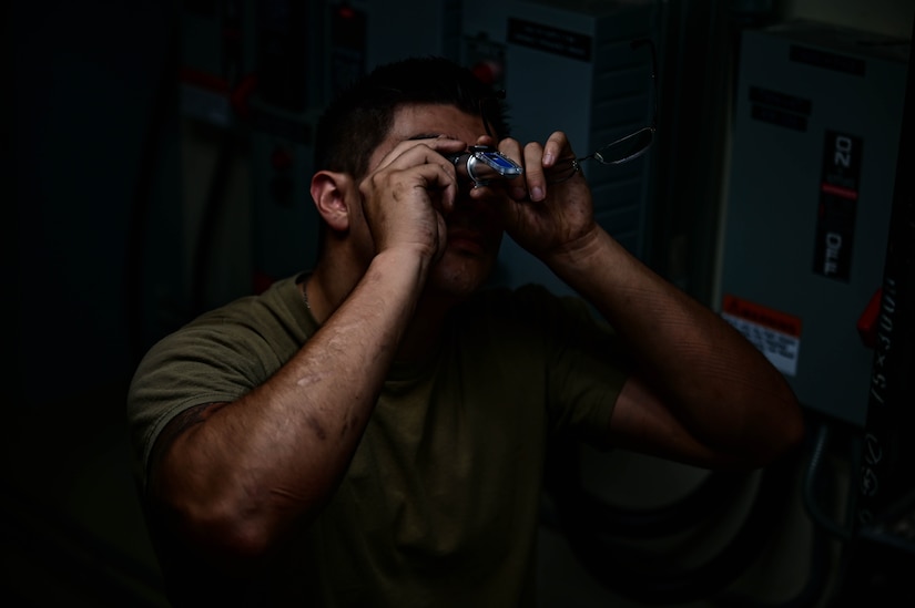 Airmen looks into device that measures chemicals in water.