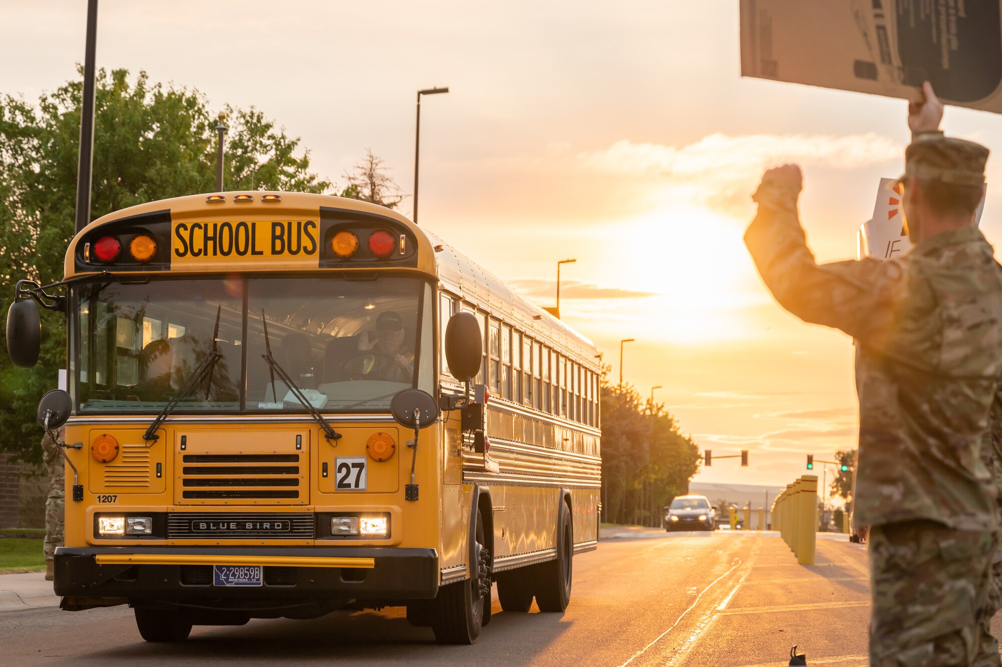 Members of the 341st Missile Wing wave at a school bus Sept. 9, 2022, at Malmstrom Air Force Base, Mont.