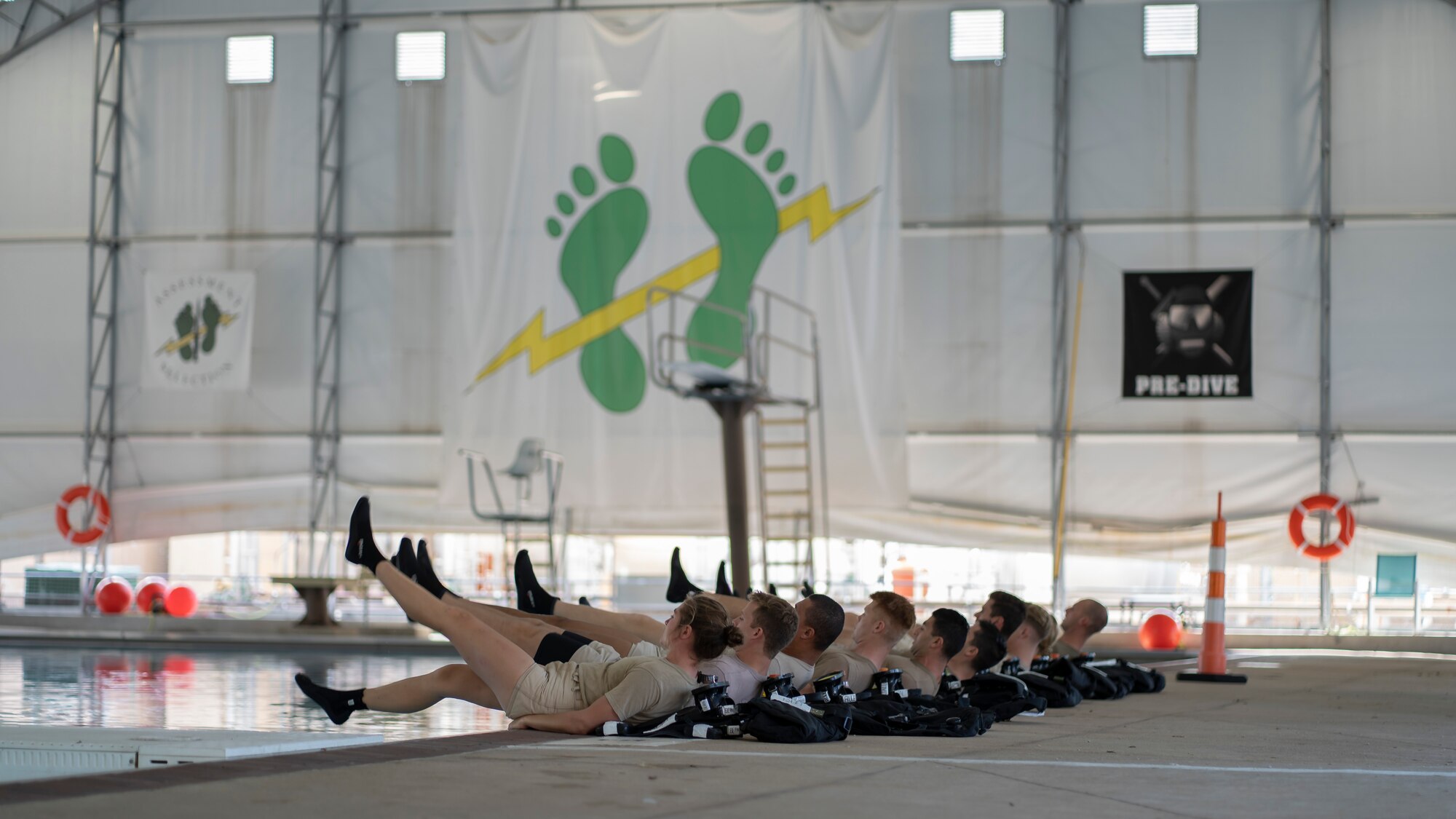 Special Warfare Training Wing trainees perform flutter kicks at Joint Base San Antonio-Lackland, Texas, Oct. 21, 2021.  Modified mixed-sex facilities were built at the SWTW to ensure appropriate levels of privacy for mixed-sex cohorts of trainees and to bolster diversity, inclusion and integration.