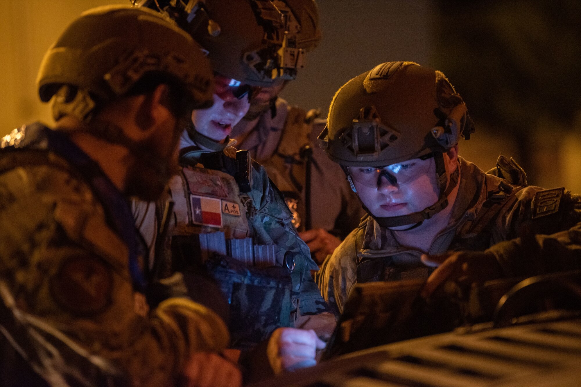 U.S. Air Force members look at a screen.