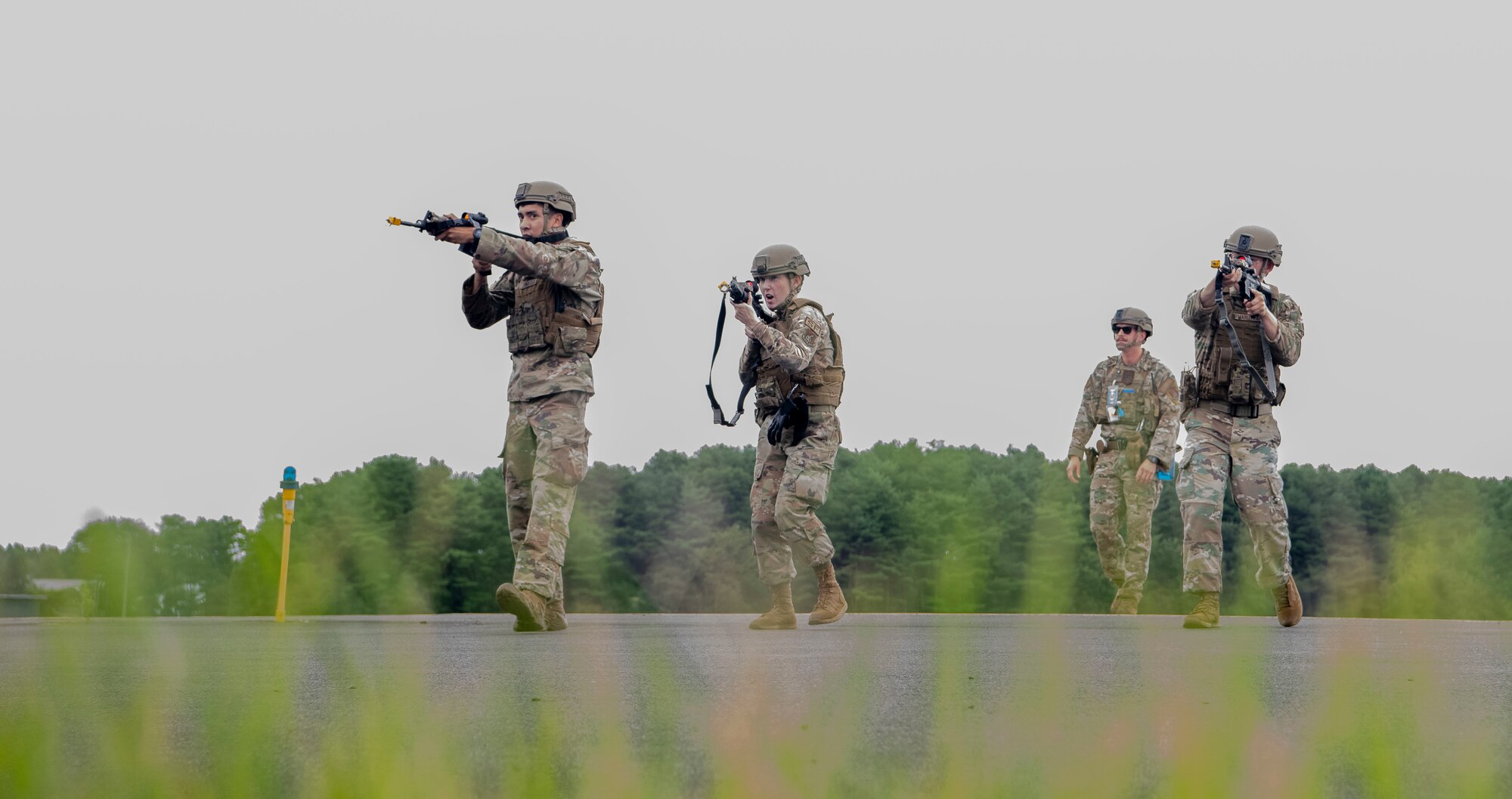 U.S. Air Force members holding rifles respond to a simulated perimeter breach.