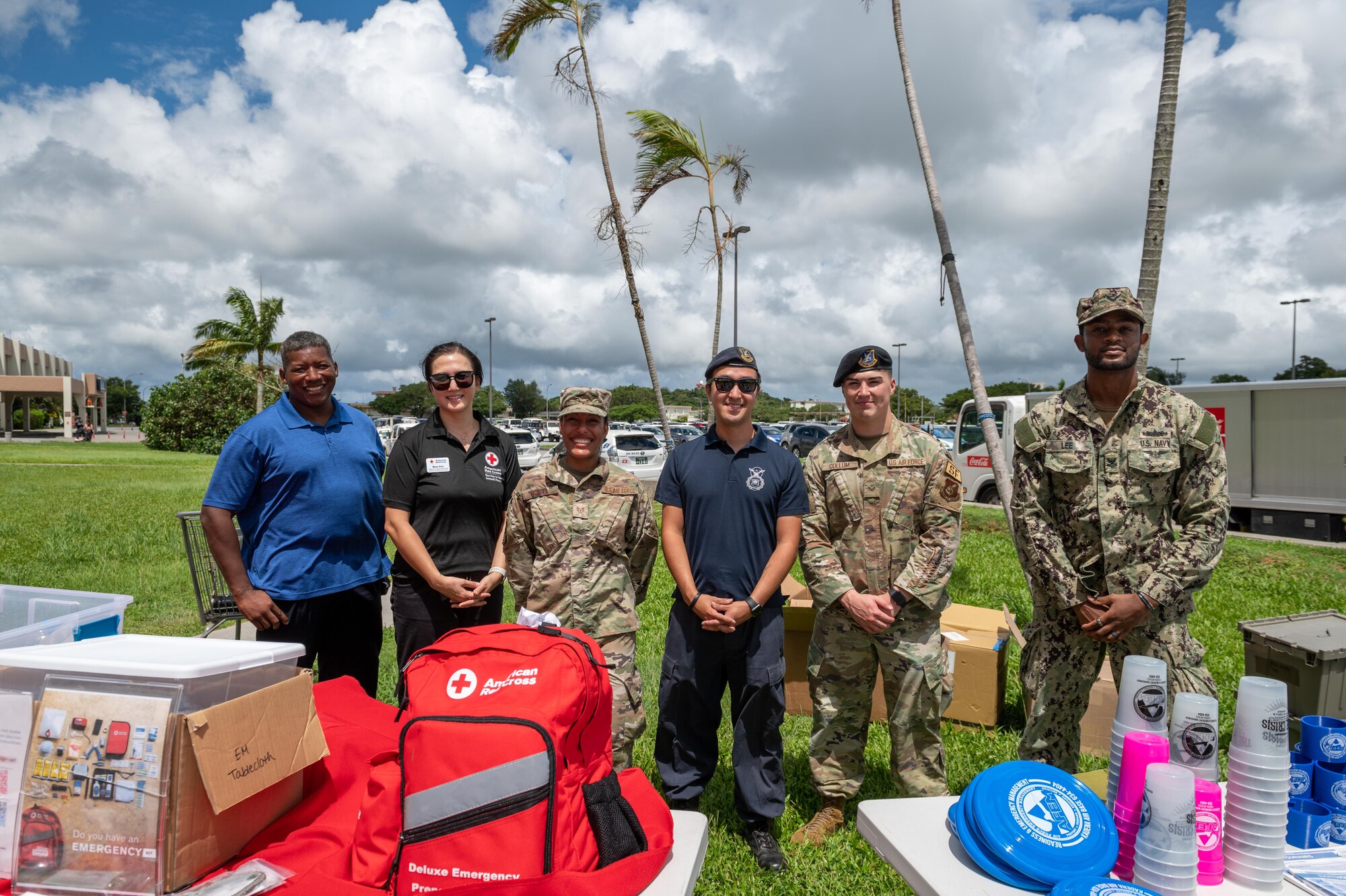 Members of the Commander Fleet Activities Okinawa, the American Red Cross and the 18th Wing stand outside the Kadena Base Exchange