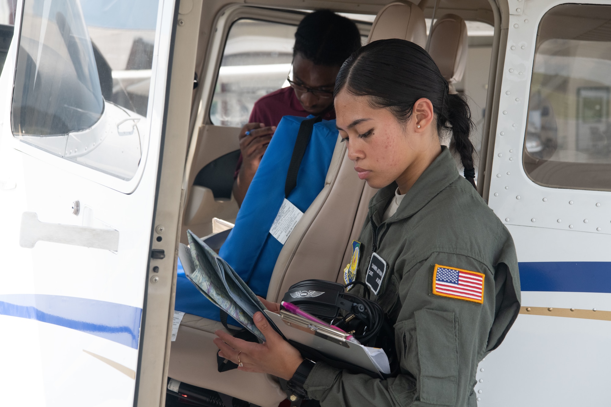 Air Force Cadet Shannen Justiniani, gathers her flight gear after a flight at Salisbury, Maryland, August 10, 2022. Justiniani wants to Commission in the Air Force and become a pilot.