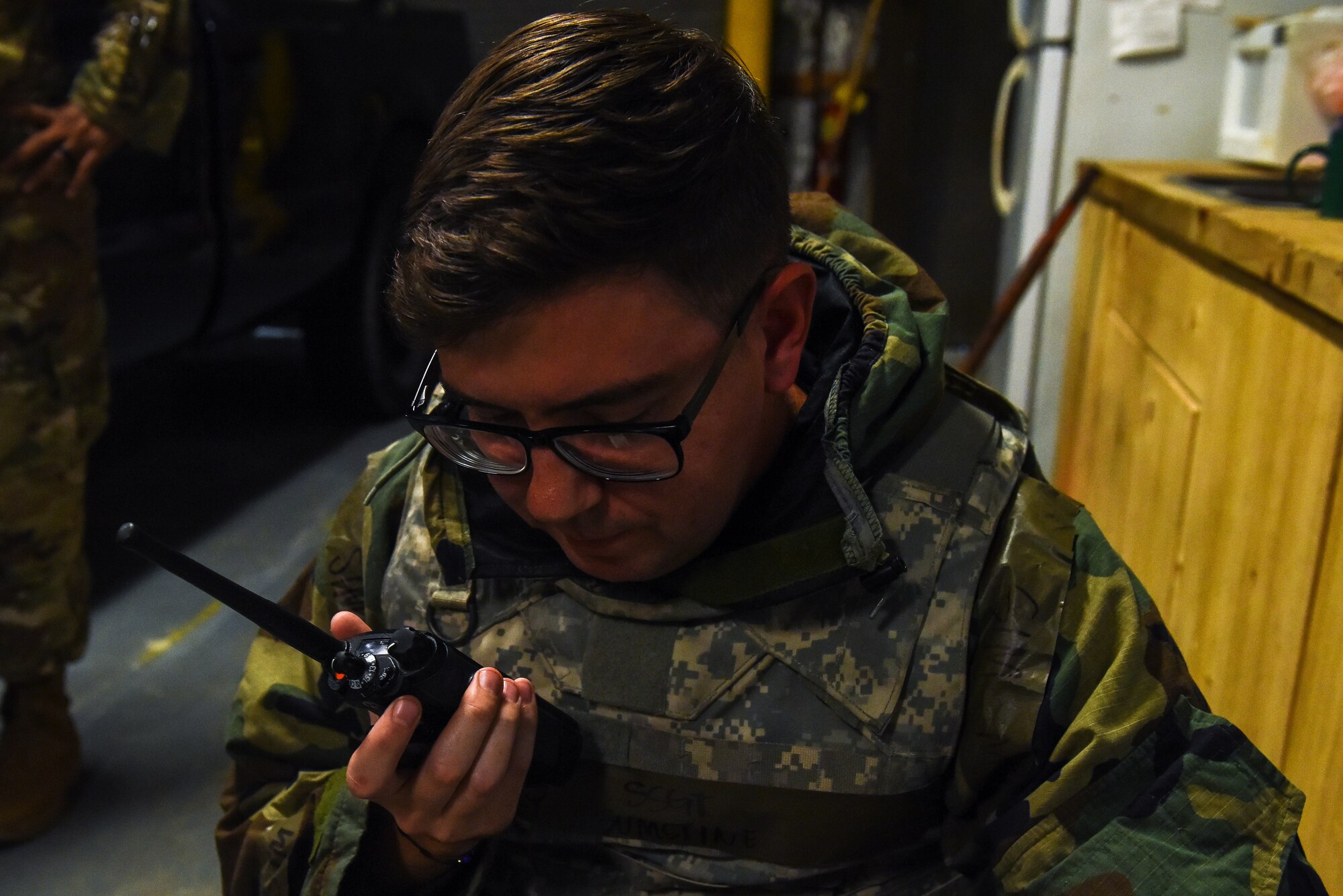 U.S. Air Force Staff Sgt. Zachary Sumstine, 8th Civil Engineer Squadron structural craftsman, communicates via radio while treating a simulated casualty during a training event on Kunsan Air Base, Republic of Korea, Sept. 9, 2022. Sumstine utilized his Airman’s Manual quick reference cards, which provide steps for treating ailments such as head, neck, and spinal injuries. (U.S. Air Force photo by Tech. Sgt. Timothy Dischinat)