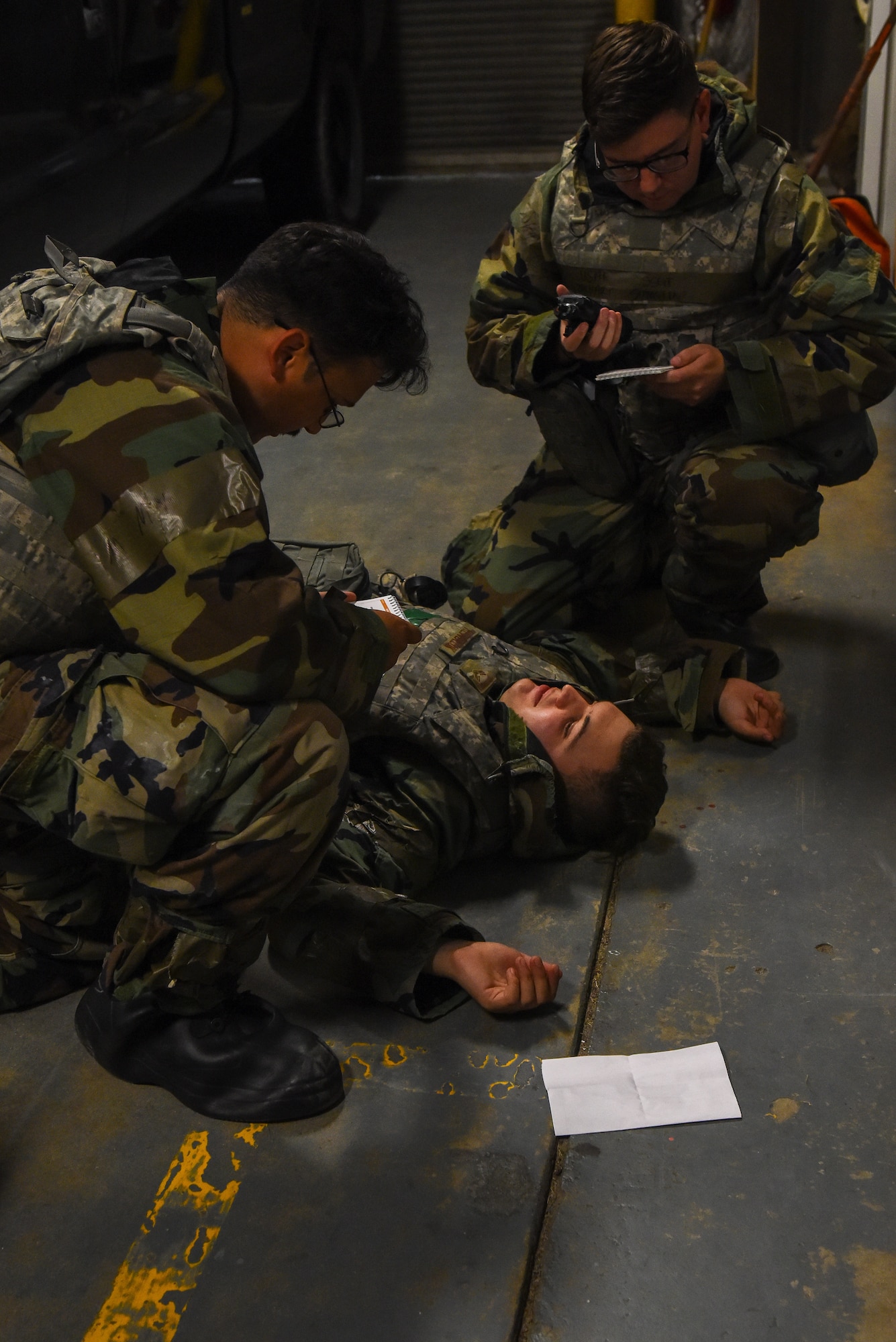 U.S. Air Force Senior Airman Jamie Canales, 8th Civil Engineer Squadron water and fuels journeyman (left) provides simulated care to U.S. Air Force Senior Airman Haylen Rendeluk, 8th CES electrical journeyman, (center) while U.S. Air Force Staff Sgt. Zachary Sumstine, 8th CES structural journeyman (right), assists, during a training event on Kunsan Air Base, Republic of Korea, Sept. 12, 2022. Airmen work in teams to prevent a teammate from having to deal with treating an injury alone. (U.S. Air Force photo by Tech. Sgt. Timothy Dischinat)