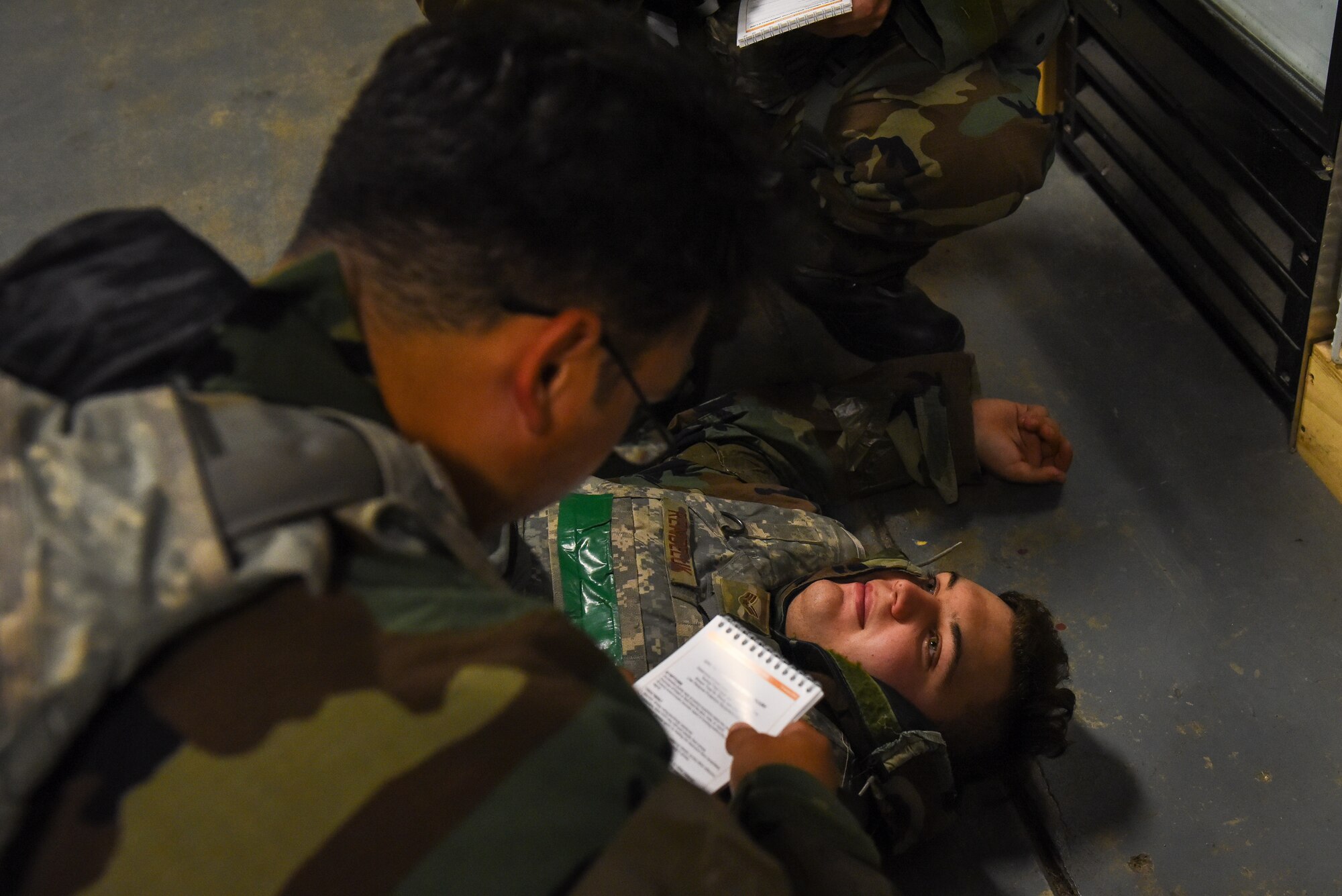 U.S. Air Force Senior Airman Jamie Canales, 8th Civil Engineer Squadron water and fuels journeyman, provides tactical combat casualty care (TCCC) to a simulated injury on U.S. Air Force Senior Airman Haylen Rendeluk, 8th CES electrical journeyman, during a training event on Kunsan Air Base, Republic of Korea, Sept. 12, 2022. Training scenarios are designed to ensure Airmen are ready and prepared for real-world situations.  (U.S. Air Force photo by Tech. Sgt. Timothy Dischinat)