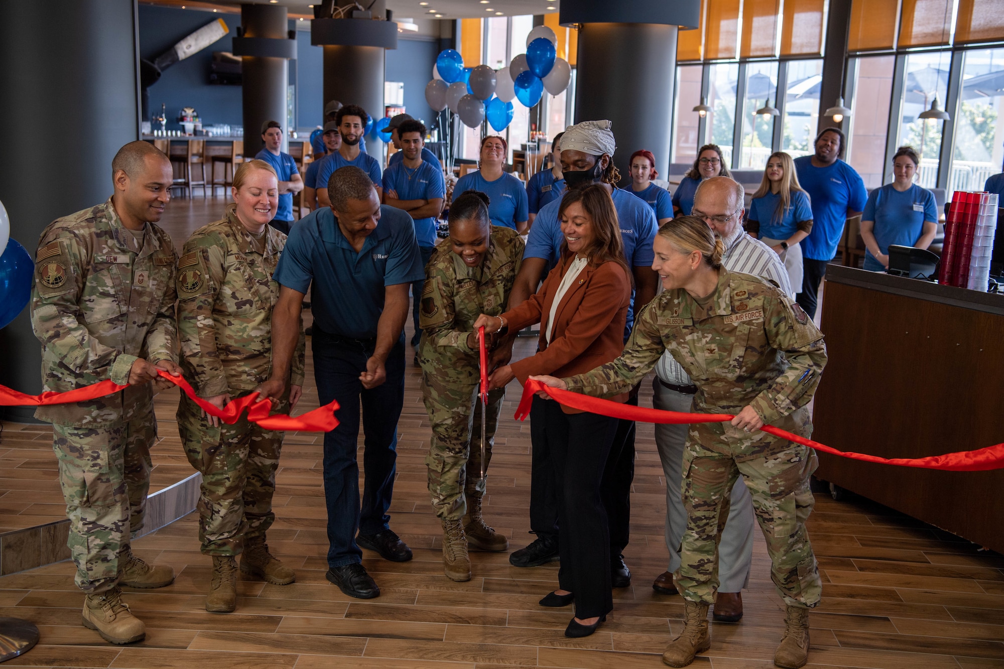 Representatives from 86th Airlift Wing, 86th Mission Support Group, and 86th Facility Support Squadron participate in the HEROES restaurant grand opening ribbon cutting ceremony at the Kaiserslautern Military Community Center at Ramstein Air Base, Sept.12, 2022.