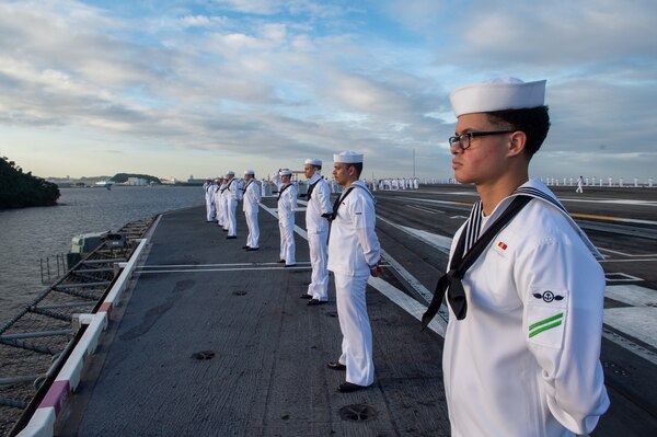 220912-N-IG750-1070  YOKOSUKA, Japan (Sept. 12, 2022) Sailors man the rails on the flight deck aboard the U.S. Navy’s only forward-deployed aircraft carrier, USS Ronald Reagan (CVN 76), as the ship departs Commander, Fleet Activities Yokosuka, Sept. 12. Ronald Reagan, the flagship of Carrier Strike Group 5, provides a combat-ready force that protects and defends the United States, and supports alliances, partnerships and collective maritime interests in the Indo-Pacific region. (U.S. Navy photo by Mass Communication Specialist 2nd Class Caleb Dyal)