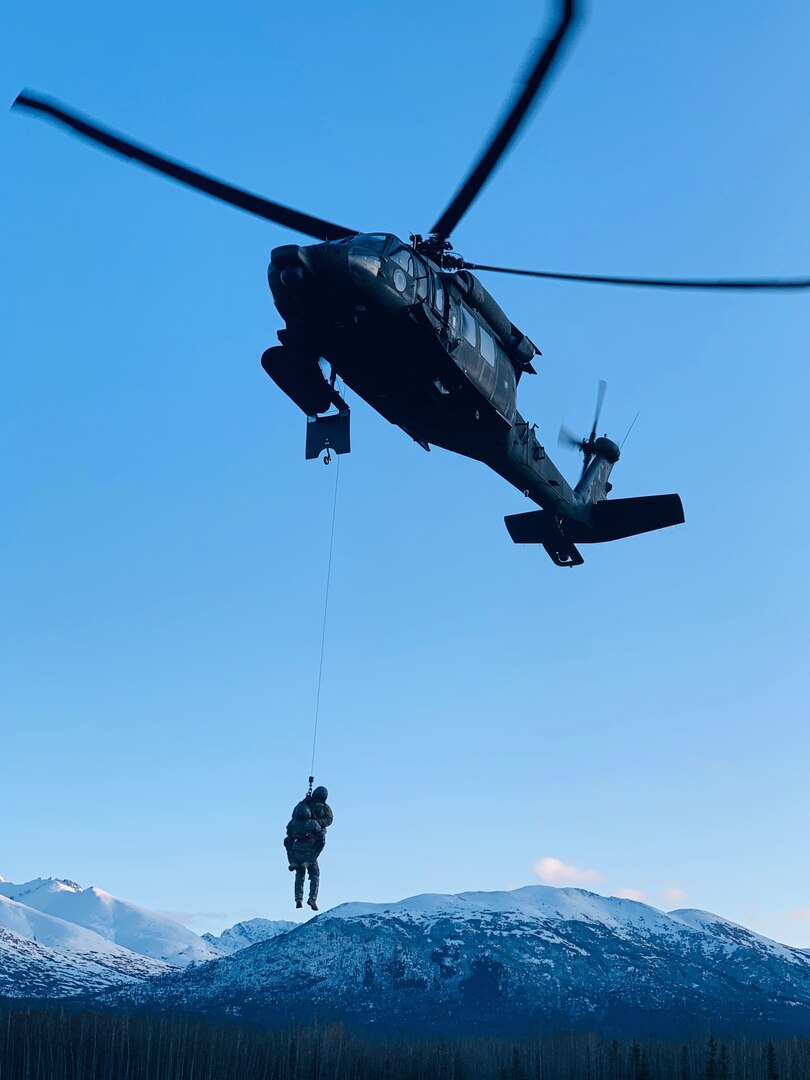 Members of the Alaska Army National Guard's 207th Aviation Regiment conduct hoist training on Joint Base Elmendorf-Richardson Feb. 20, 2020.