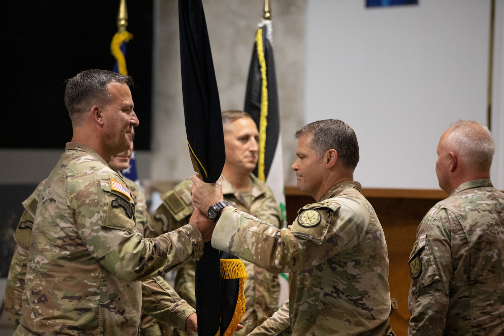U.S. Army Gen. Michael E. Kurilla, commander of U.S. Central Command, receives the unit colors from Maj. Gen. John W. Brennan, then commanding general of Combined Joint Task Force – Operation Inherent Resolve, during a transfer of authority ceremony in Baghdad, Iraq, Sept. 8, 2022. Brennan relinquished command to Maj. Gen. Matthew McFarlane. (U.S. Army photo by Sgt. Julio Hernandez)