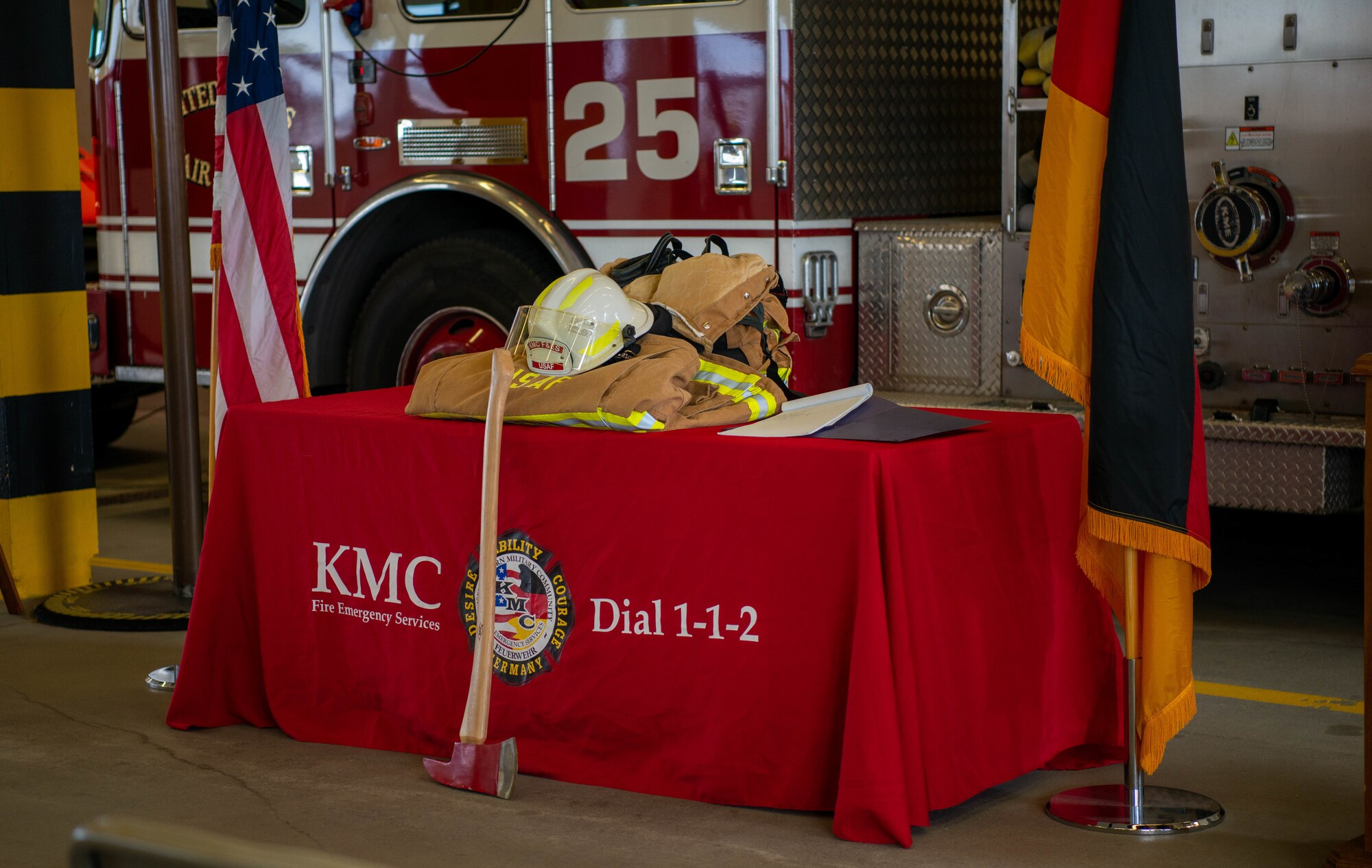 A display of a firefighter’s uniform and an ax rest on a table are available for viewing as a visual representation for a 9/11 memorial at Ramstein Air Base, Germany, Sept. 9, 2022.