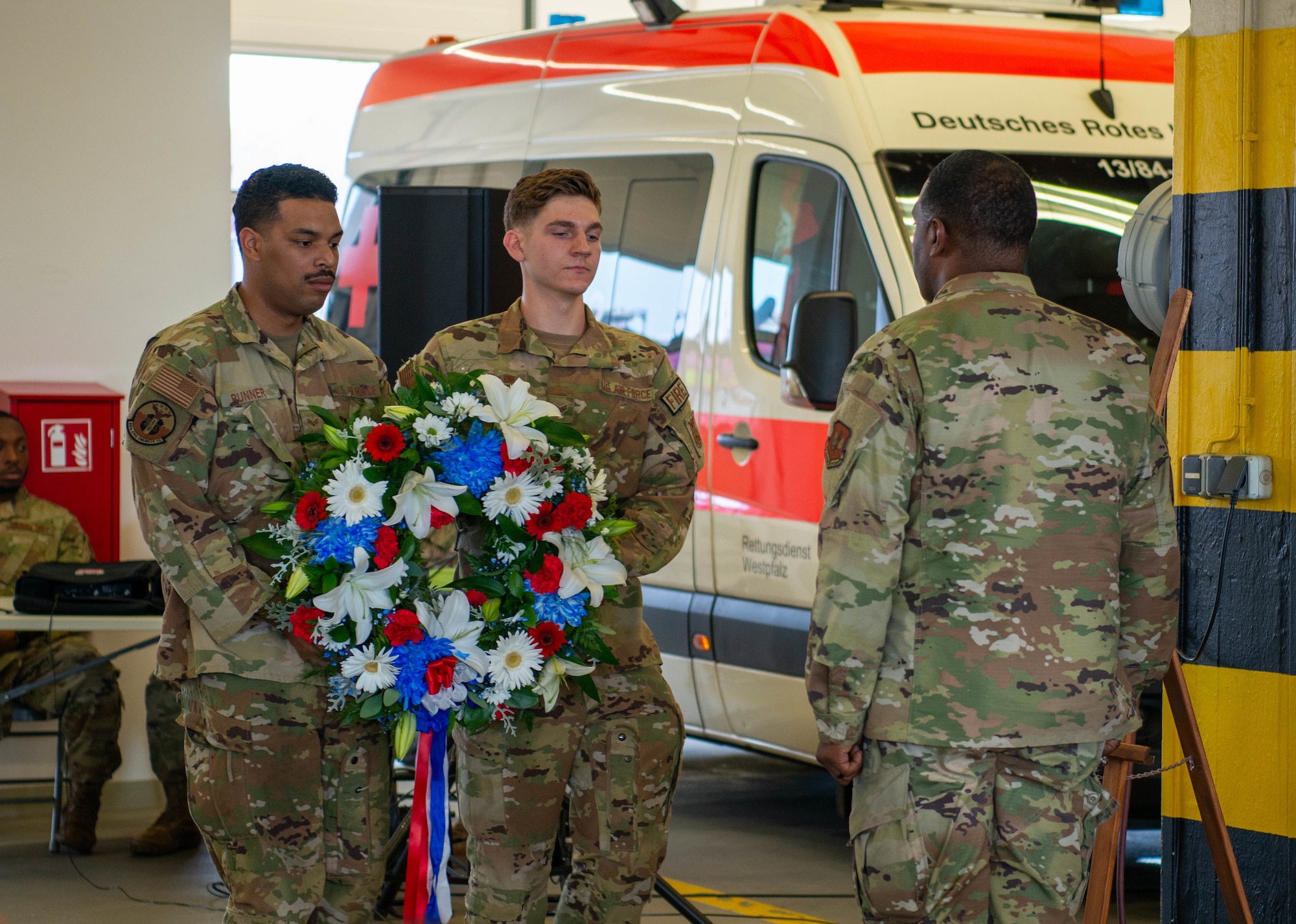 U.S. Air Force Brig. Gen. Otis C. Jones, right, 86th Airlift Wing commander, and Airmen assigned to the 86th Civil Engineer Squadron fire and emergency services present a ceremonial wreath at Ramstein Air Base, Germany, Sept. 9, 2022.