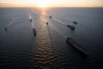 (Sept. 4, 2022) From left, The Norwegian Fridtjof Nansen-class frigate HNoMS Roald Amundsen (F331), the U.S. Navy San Antonio-class amphibious transport dock ship USS Arlington (LPD 24), the Norwegian replenishment oiler HNoMS Maud (A530), the U.S. Navy Wasp-class amphibious assault ship USS Kearsarge (LHD 3), the Portuguese Vasco Da Gama-class frigate NRP Corte-Real (F332), the Royal Netherlands Navy multi-mission support ship HNLMS Karel Doorman (A 833), the U.S. Navy Whidbey Island-class dock landing ship USS Gunston Hall (LSD 44), and the U.S. Navy Arleigh Burke-class destroyer USS Paul Ignatius (DDG 117), sail in formation during a maneuvering exercise Sept. 4, 2022. The Kearsarge Amphibious Ready Group and embarked 22nd Marine Expeditionary Unit, under the command and control of Task Force 61/2, is on a scheduled deployment in the U.S. Naval Forces Europe area of operations, employed by U.S. Sixth Fleet to defend U.S., allied and partner interests. (U.S. Navy photo by Mass Communication Specialist 2nd Class Jesse Schwab)